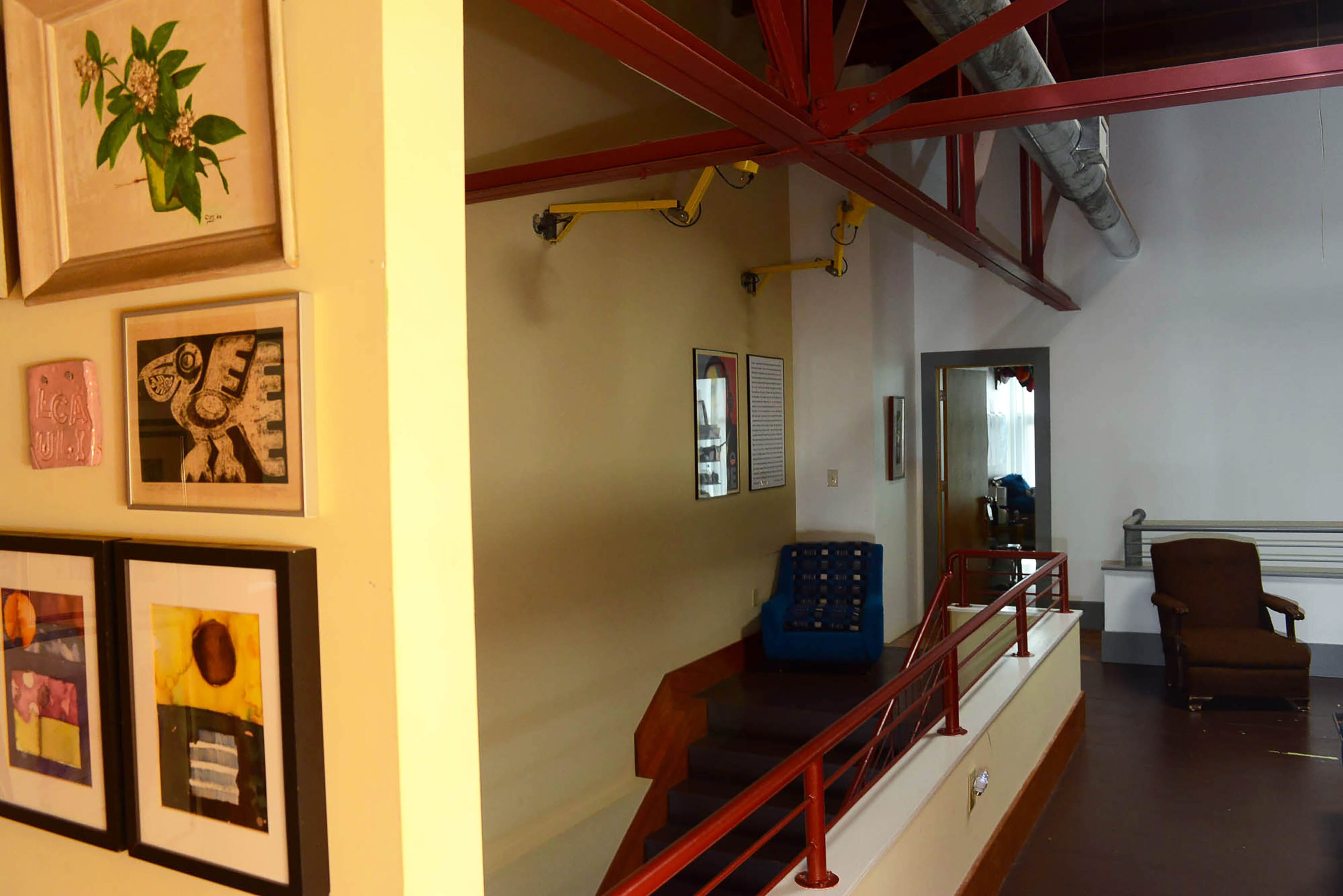 Exposed red beams and pipes pay homage to the building's original use as a warehouse.