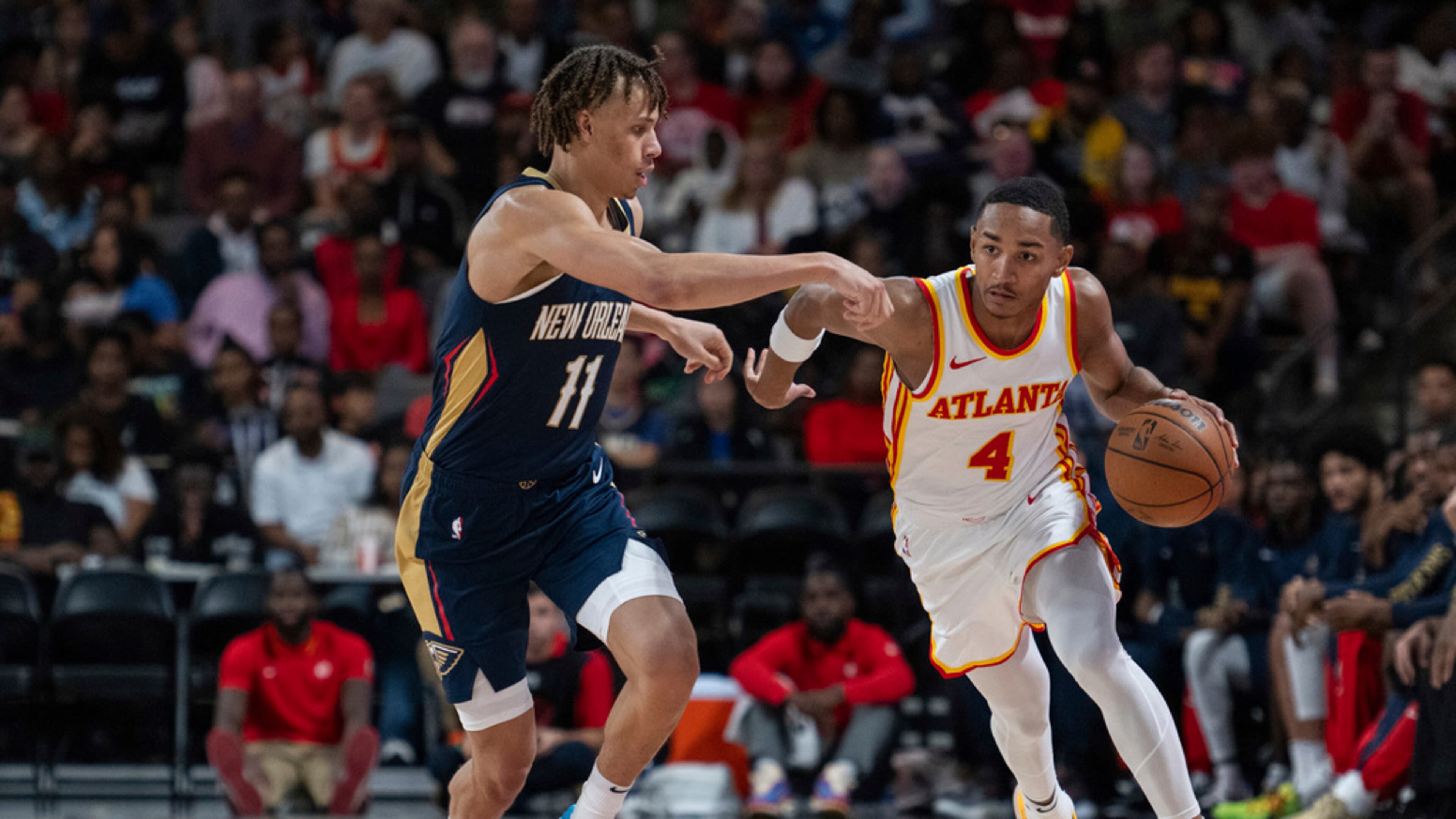 Hawks guard Kobe Bufkin dribbles against Pelicans guard Dyson Daniels (11) during the second half Saturday, Oct. 14, 2023, in College Park, Ga. (AP Photo/Hakim Wright Sr.)