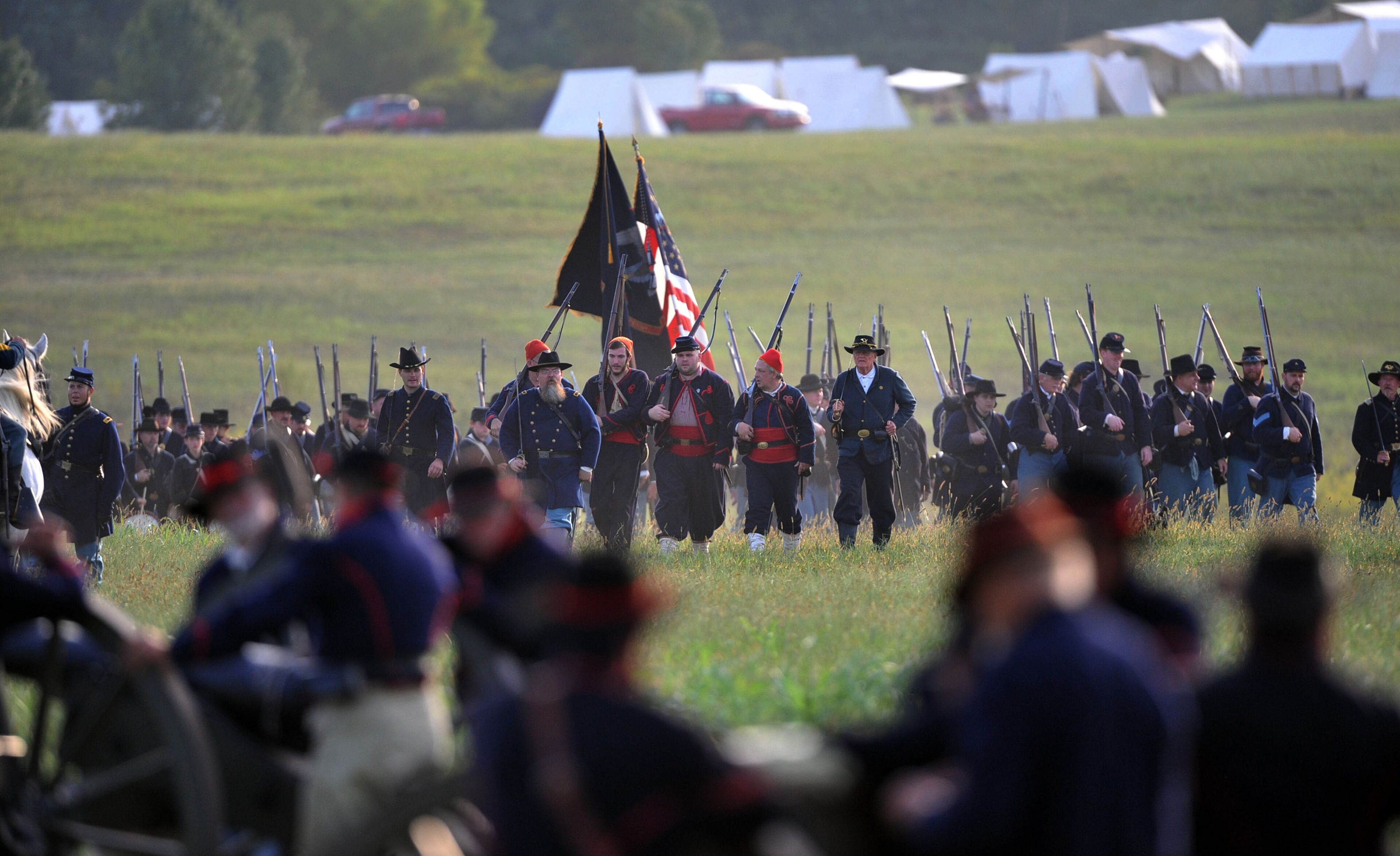 Union troops arrive on the battle scene. Confederate and Union reenactors recreate the Battle of Utoy Creek during the Atlanta Campaign's Battle of Atlanta re-enactment at the Nash Farm Battlefield Friday, September 19, 2014. Thousands of re-enactors and spectators are expected to descend on Nash Farm Battlefield for this weekend's Battle of Atlanta events starting Friday and ending Sunday afternoon. Kilpatrick's Raid, the Battle of Cheatham's Hill, and Battle of Atlanta will be reenacted Saturday and Sunday. Confederate and Federal troops are in separate encampments about a 1/2 mile apart at the site. KENT D. JOHNSON / KDJOHNSON@AJC.COM