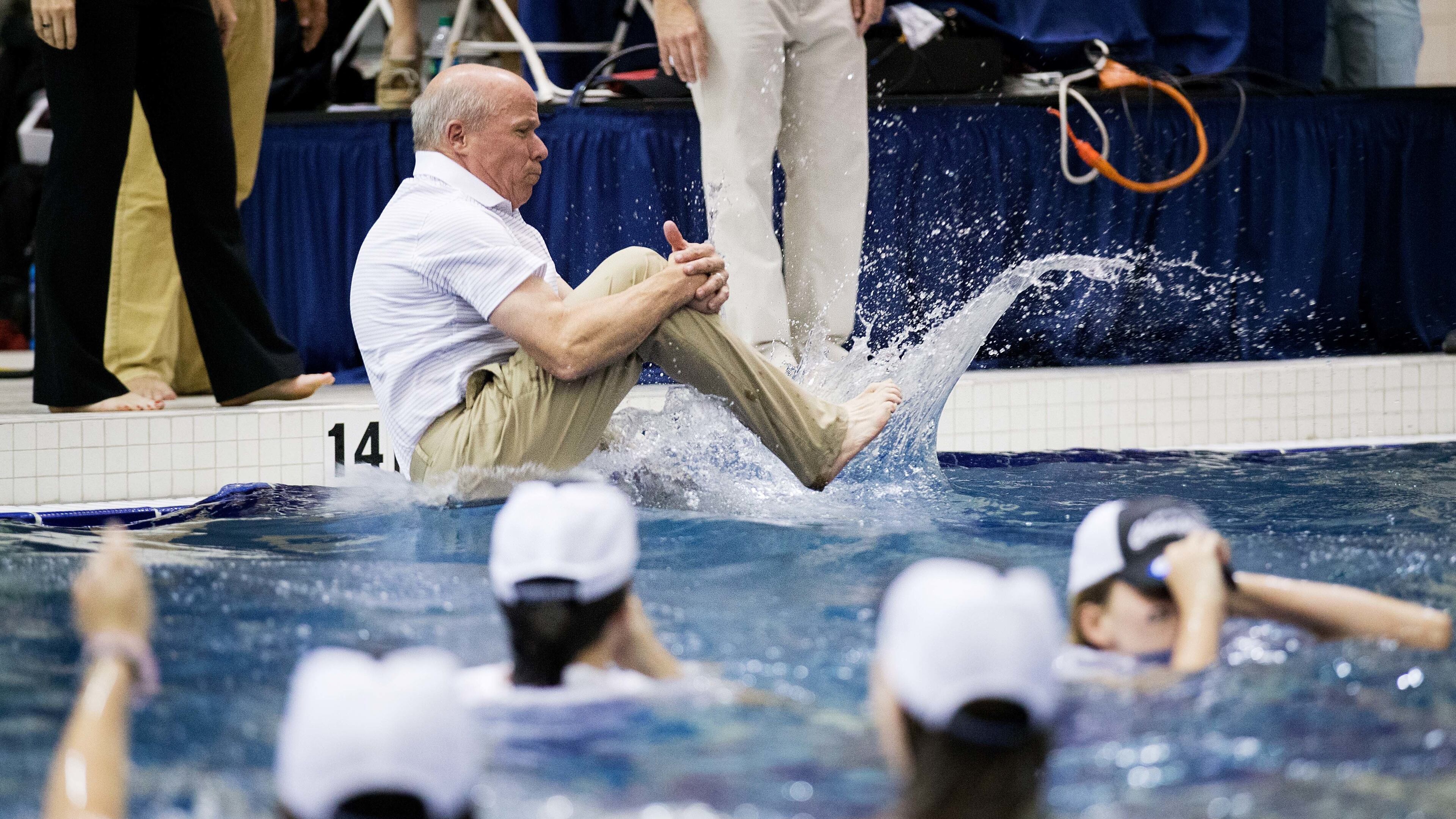 Georgia coach Jack Bauerle jumps into the water as the team celebrates after winning the NCAA women's swimming and diving championships in March 2016 in Atlanta. (AP Photo/David Goldman)