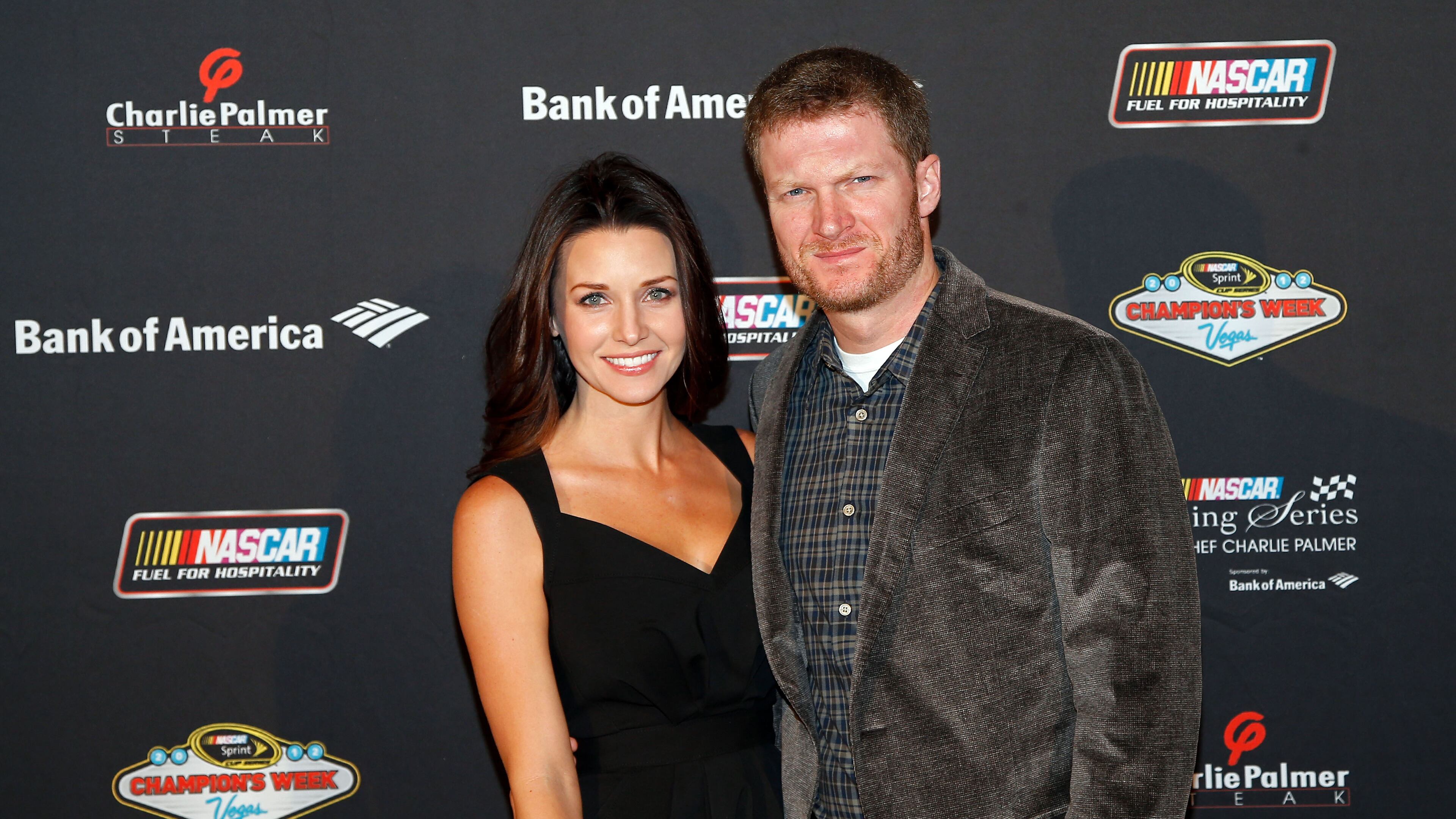 LAS VEGAS, NV - NOVEMBER 28: Driver Dale Earnhardt Jr. (R) and Amy Reimann (L) pose during the NASCAR Evening Series at Charlie Palmer Steak part of the Four Seasons Hotel Las Vegas on November 28, 2012 in Las Vegas, Nevada. (Photo by Chris Graythen/Getty Images for NASCAR)