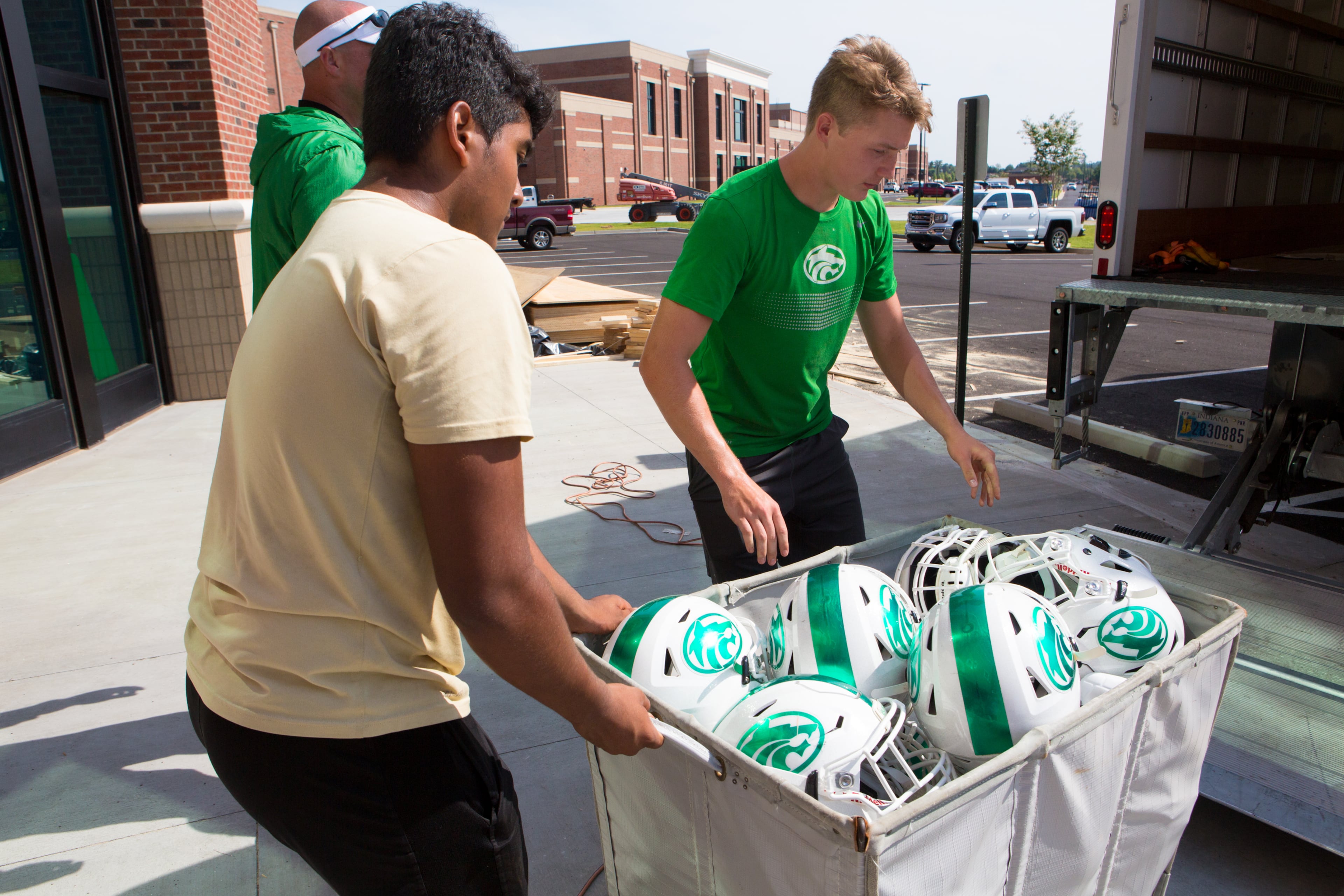 Members of the Buford High School football team help load new weightlifting equipment into the school in Buford, Ga., on Thursday, July 18, 2019. Classes will begin at the, 214,000 square foot school on August 7. (Casey Sykes for The Atlanta Journal-Constitution)