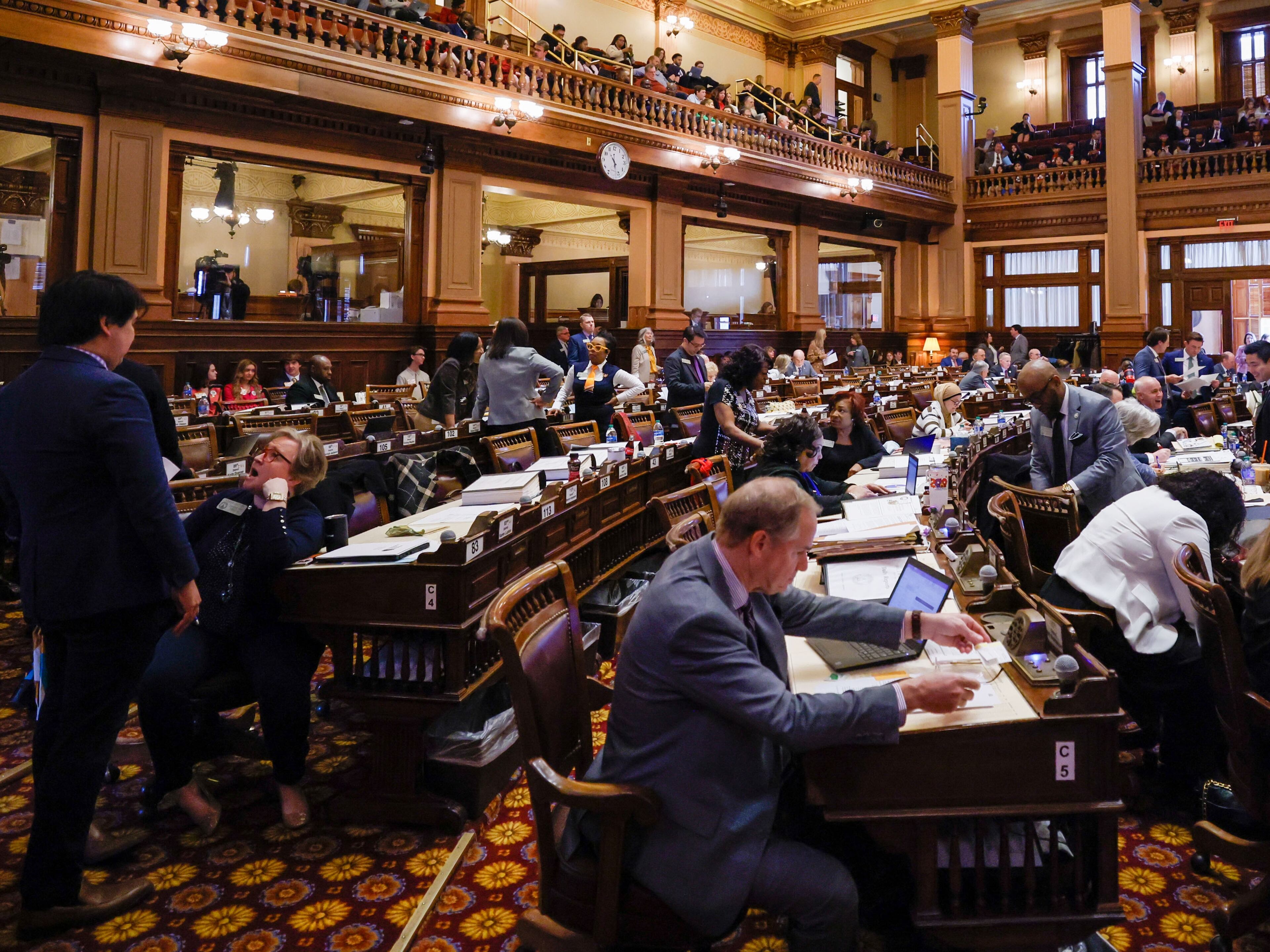 House Chamber lawmakers gather during Crossover Day at the Capitol in Atlanta on Thursday, Feb. 29, 2024. Thursday is the last day for a bill to move from one chamber to another. (Miguel Martinez / miguel.martinezjimenez@ajc.com)