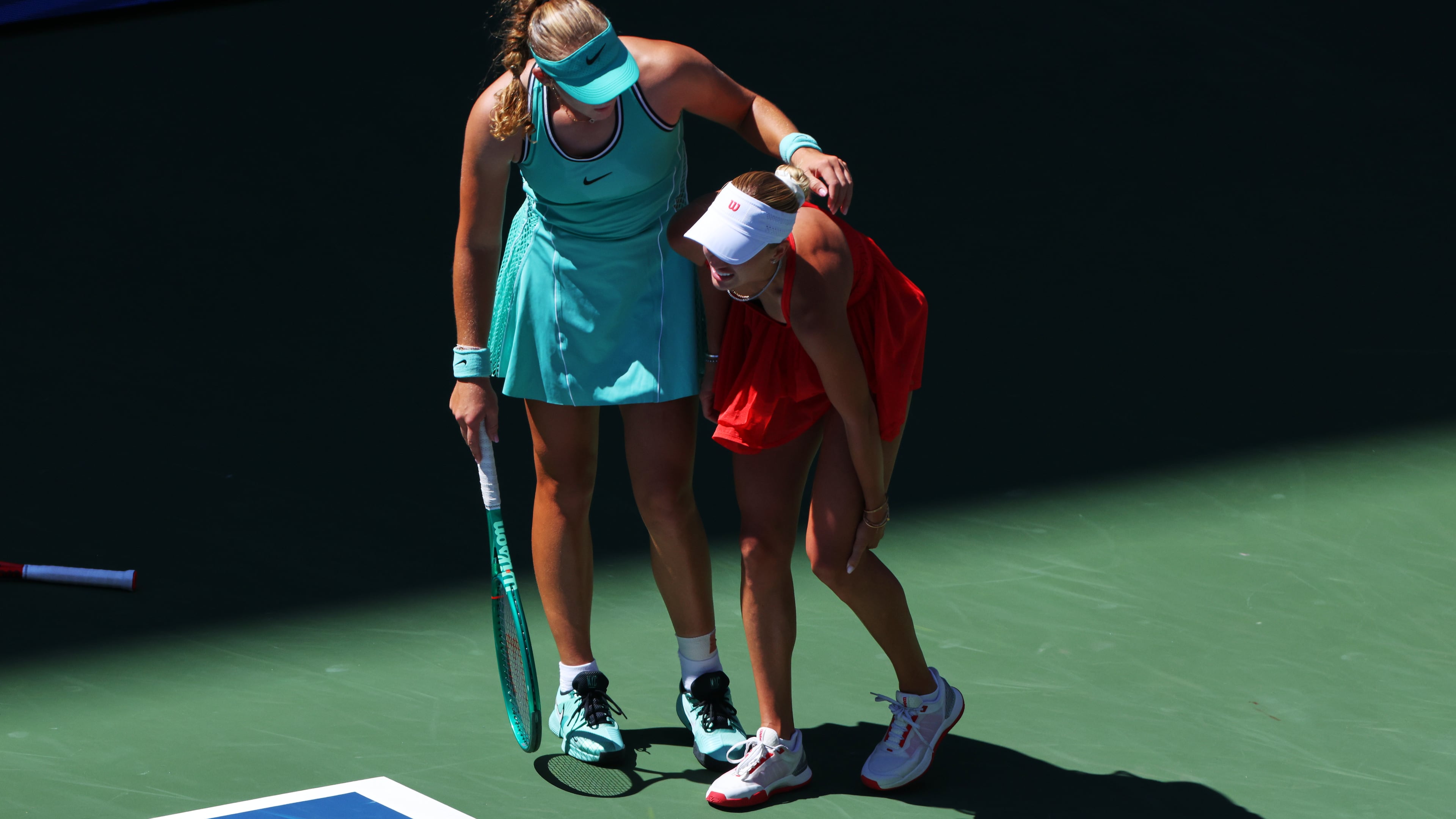 Mirra Andreeva, of Russia, left, helps Anastasia Potapova, of Austria, after Potapova fell during the fourth round of the U.S. Open tennis championships, Monday, Sept. 7, 2026, in New York. (AP Photo/Andres Kudacki)
