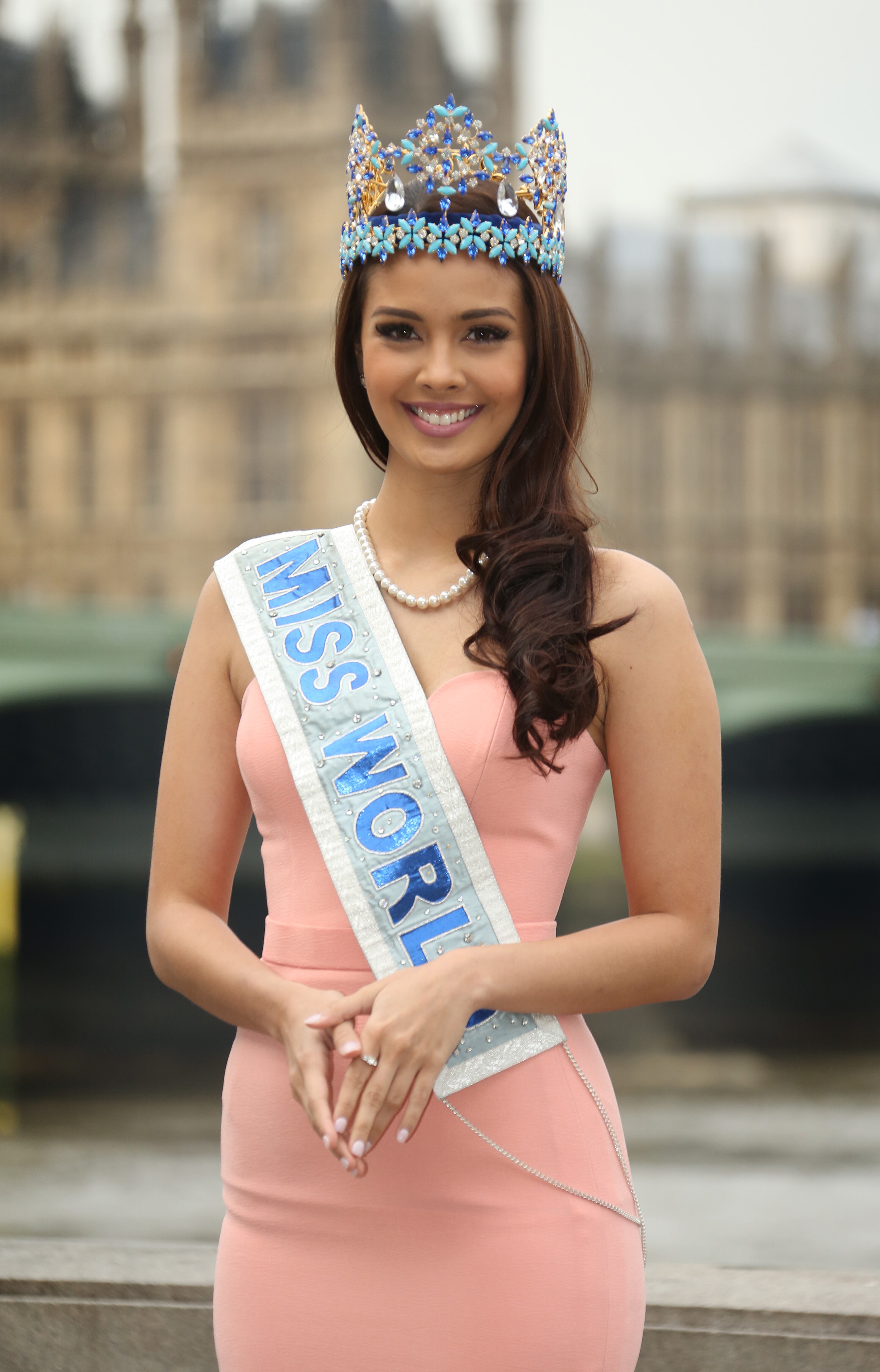 Miss World 2013 Winner Megan Young of the Philippines, poses for photographs in front of the House of Commons on the steps of a hotel next to London County Hall in Westminster, central London, Tuesday, Nov. 25, 2014. (Photo by Joel Ryan/Invision/AP)