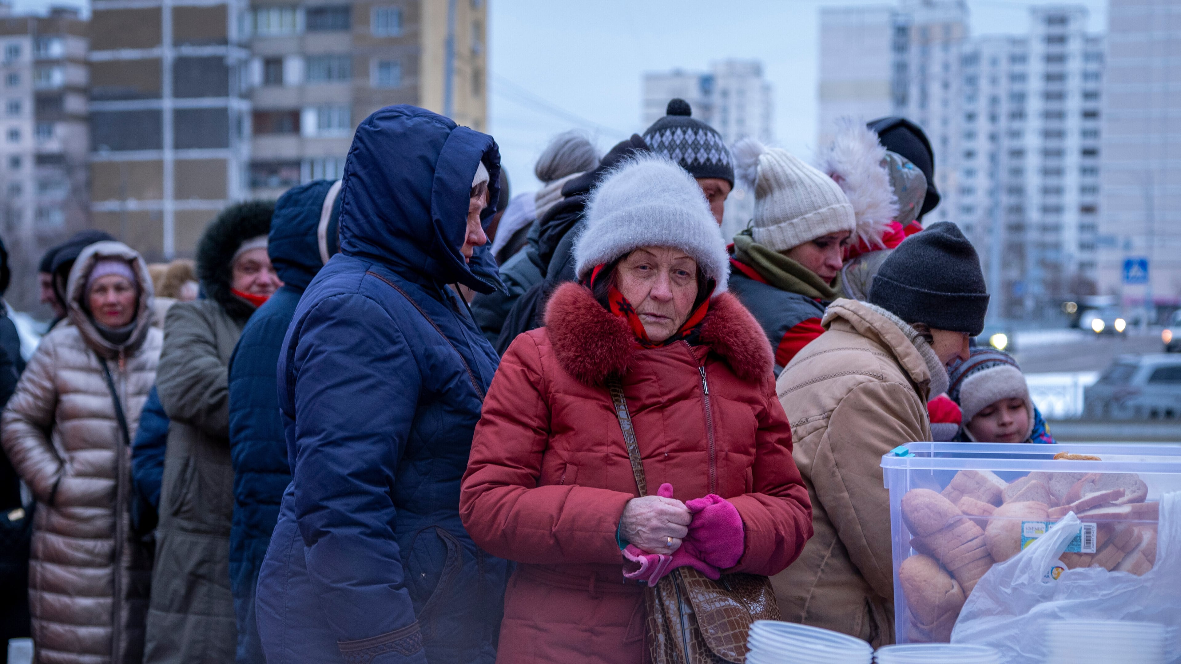 People who have no power at home following Russia's air attacks wait in line to receive free hot meals in a residential neighbourhood in Kyiv, Ukraine, Friday, Jan. 30, 2026. (AP Photo/Dan Bashakov)
