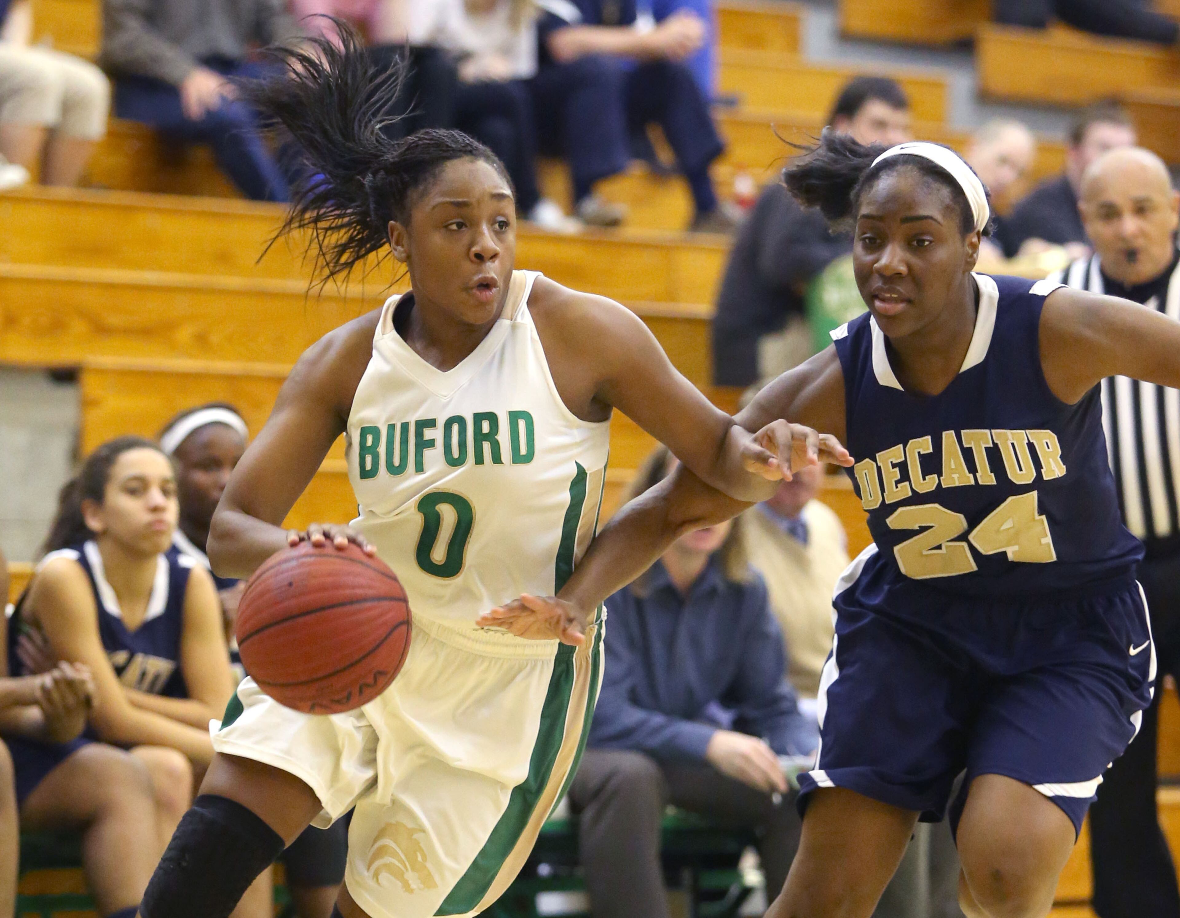 Buford's Camille Anderson (0) drives against Decatur's Janay Williams (24) in in the second round of the Class AAA state basketball tournament Monday night in Buford. Buford defeated Decatur 41-28. JASON GETZ / SPECIAL