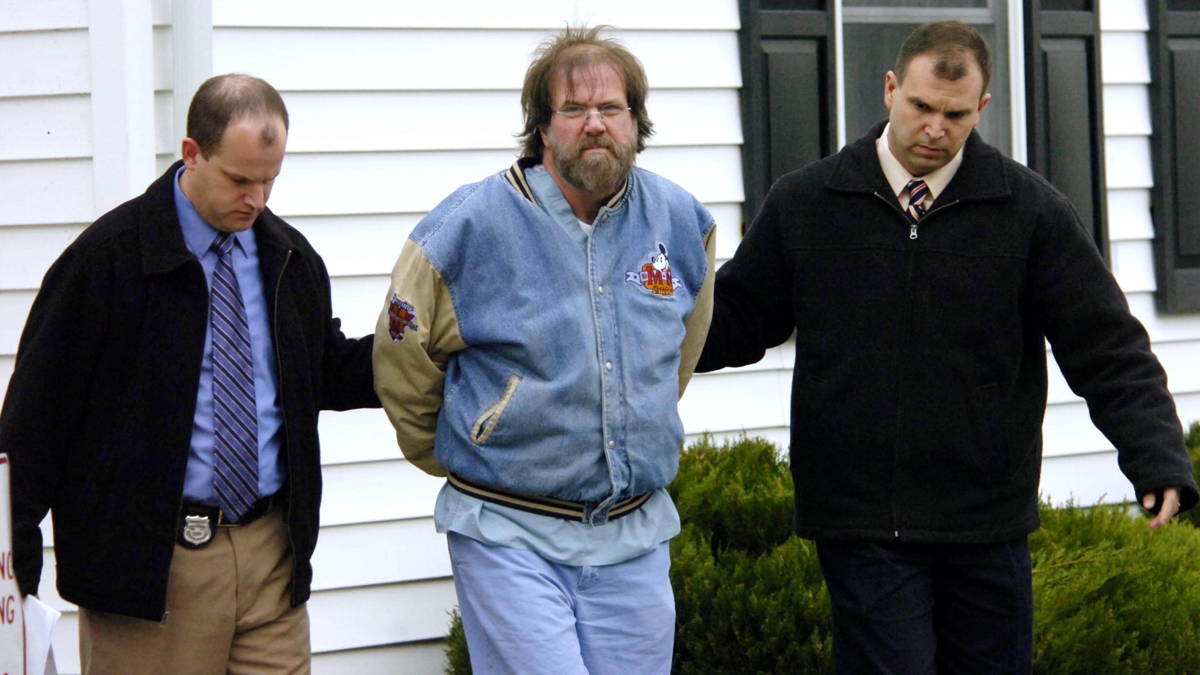 Detectives escort Dr. Earl B. Bradley following his arrest. Bradley is serving 14 life sentences. Photo/Gary Emeigh, The News Journal, File)