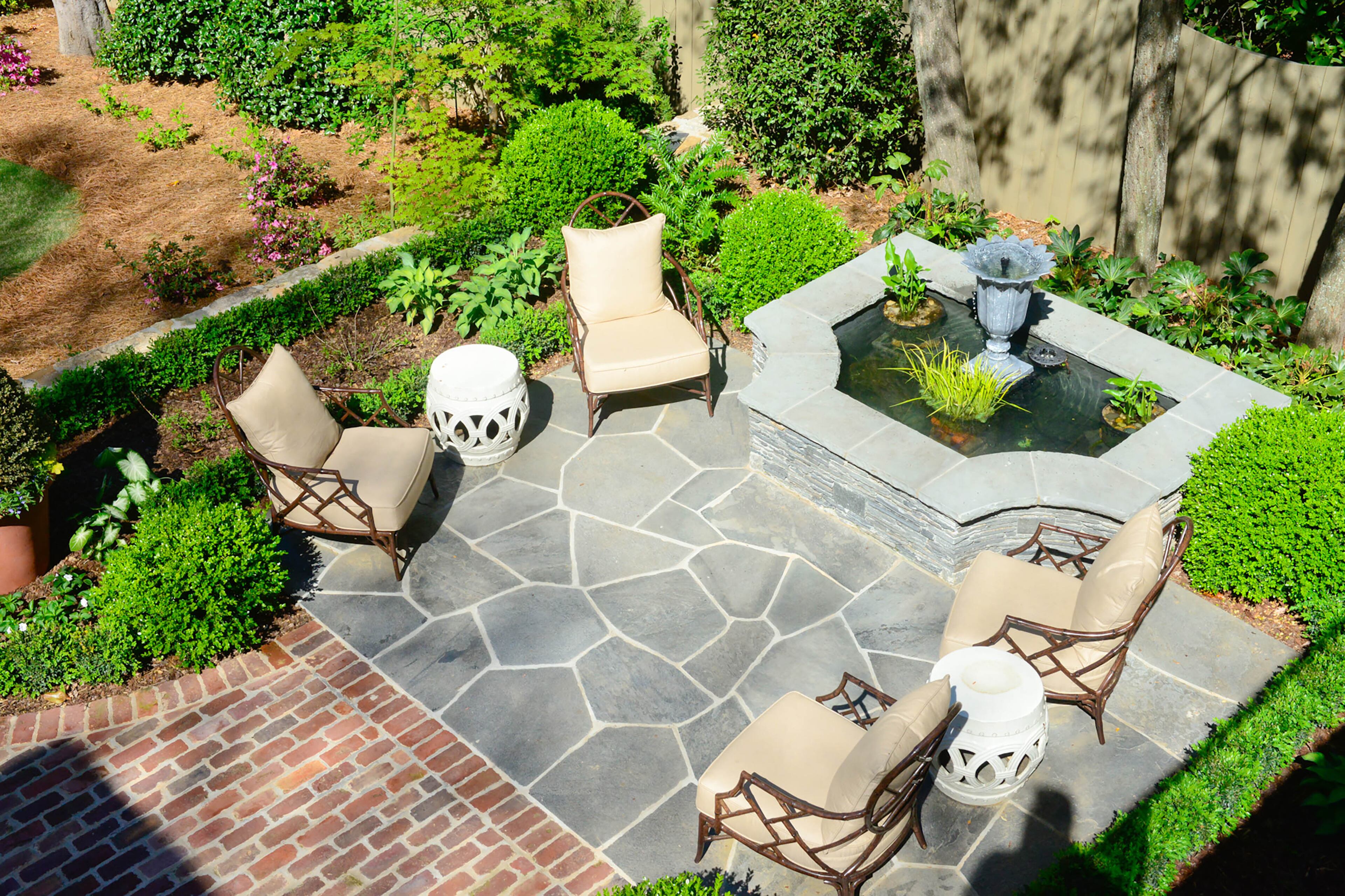 Landscape architect Richard Anderson re-envisioned the Brookwood Hills backyard with a bluestone patio and water feature in one section of the property.