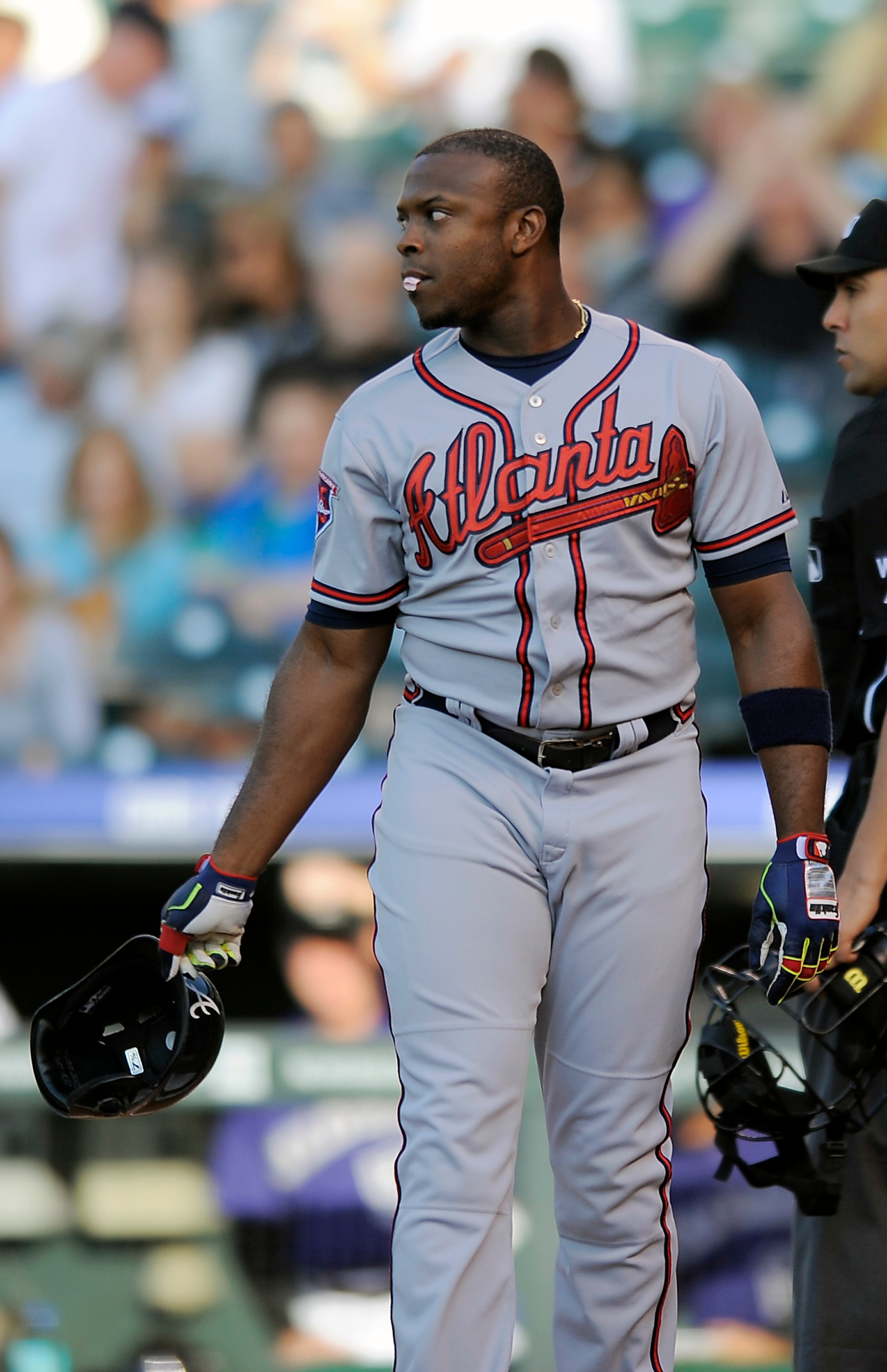 Atlanta Braves Justin Upton reacts to striking out in the first inning of a baseball game against the Colorado Rockies on Monday, June 9, 2014, in Denver. (AP Photo/Chris Schneider)