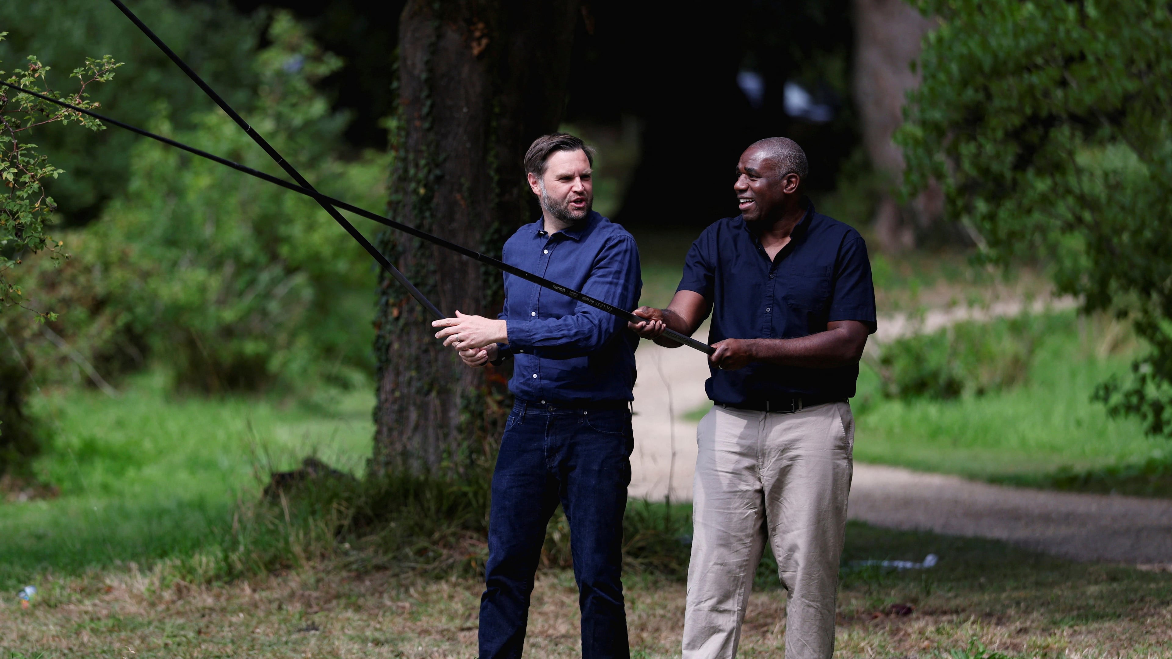 FILE - Britain's Foreign Secretary David Lammy, right, and US Vice President JD Vance fish in a lake in the grounds of Chevening House in Kent, England, Aug. 8, 2025. (Suzanne Plunkett/Pool via AP, File)