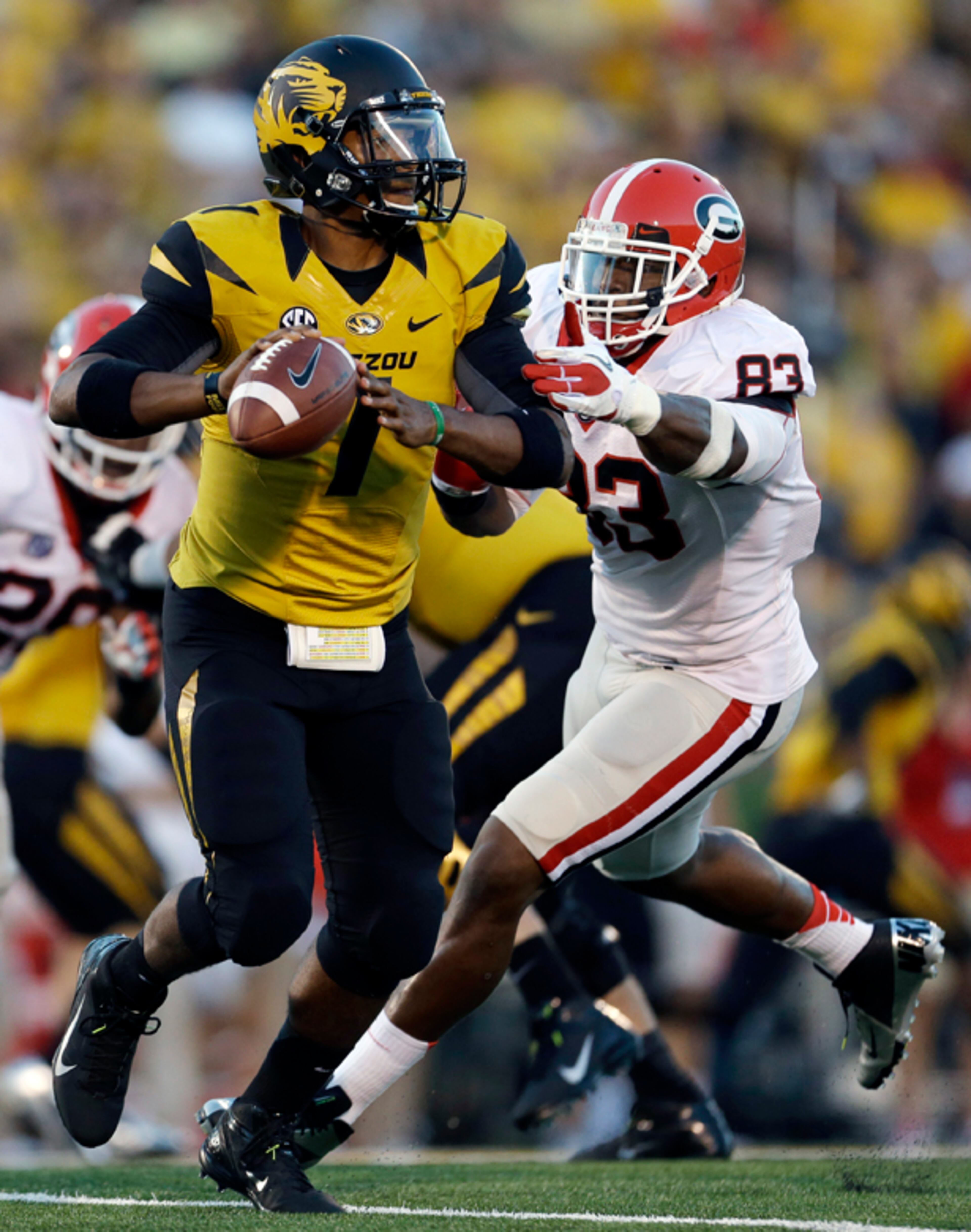 Missouri quarterback James Franklin looks to throw as Georgia linebacker Cornelius Washington closes in for a tackle.