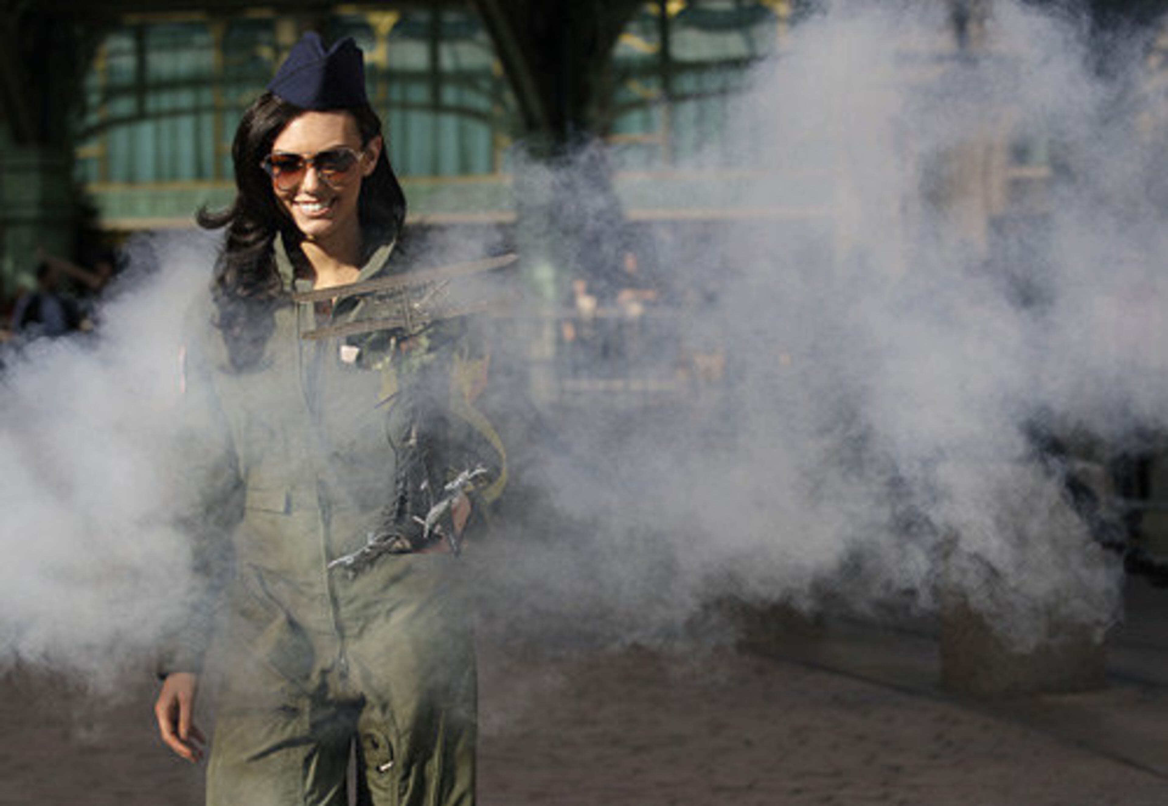 Miss Ohio, Becky Minger, wearing a flight suit to honor Ohio's history as the birthplace of aviation, walks through manufactured smoke during a photo shoot after the parade.