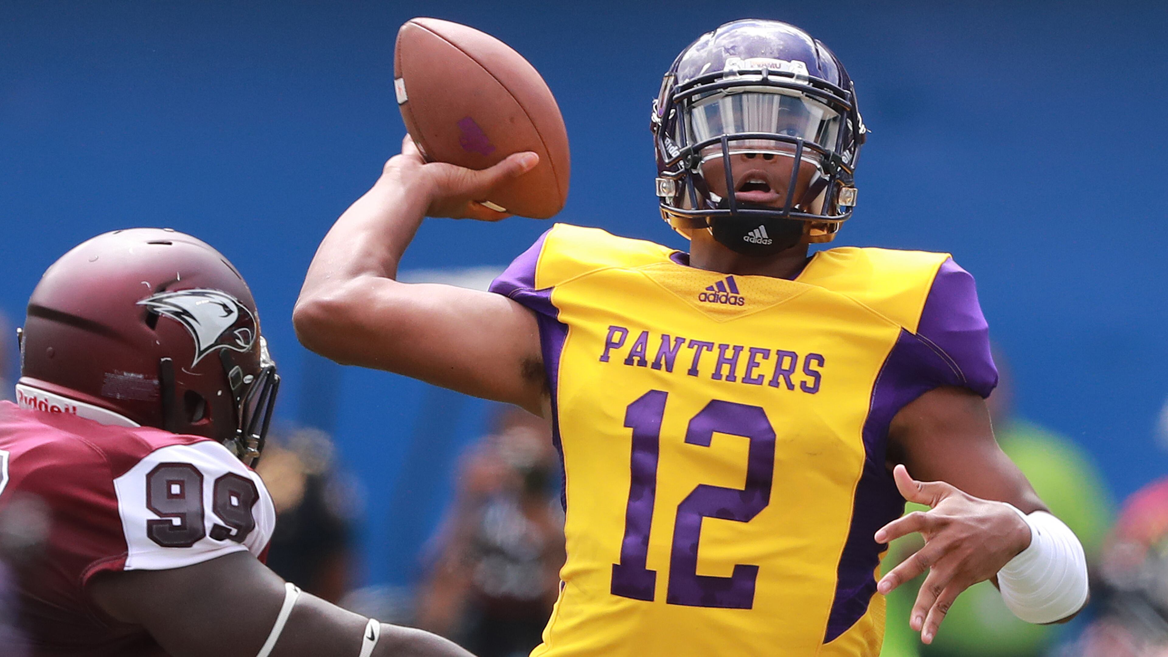 Prairie View A&M quarterback Jalen Morton gets off a pass under pressure from North Carolina Central defender Chuck Manning during the first half of the MEAC-SWAC Challenge Sunday, Sept 2, 2018, in Atlanta.