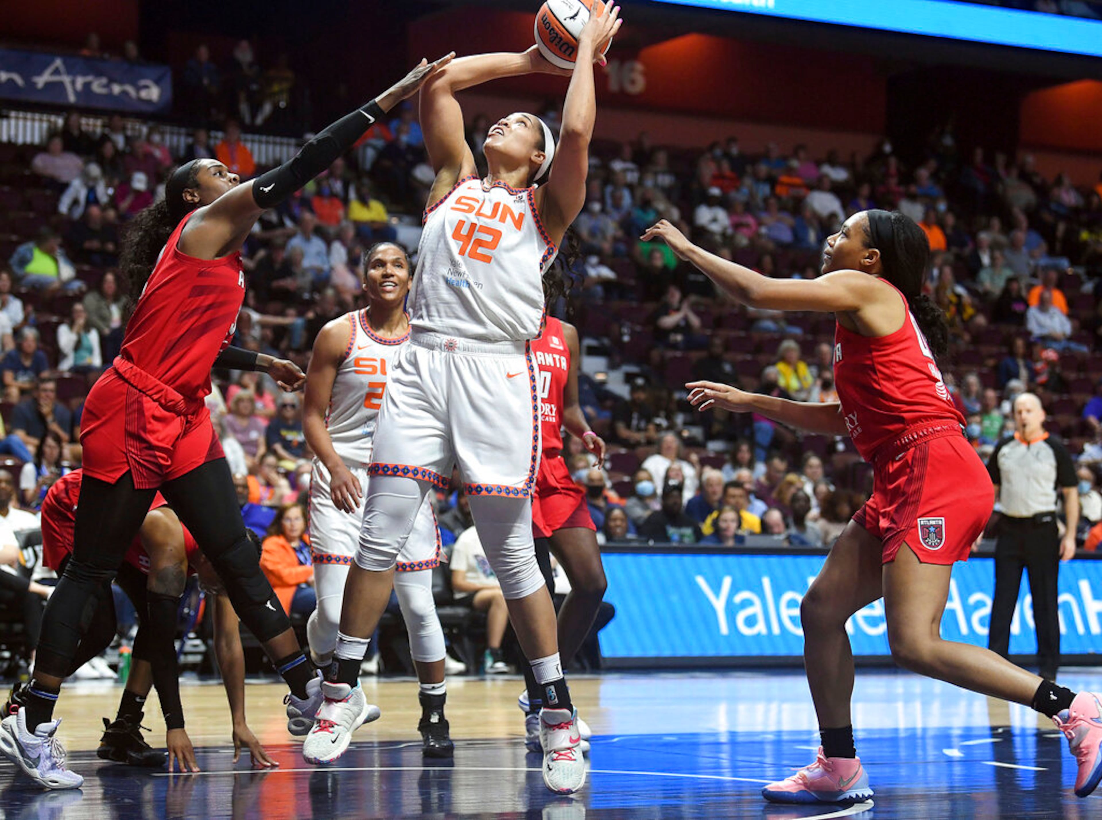 Connecticut Sun center Brionna Jones (42) shoots next to Atlanta Dream forward Cheyenne Parker (32) during a WNBA basketball game Wednesday, June 15, 2022, in Uncasville, Conn. (Sarah Gordon/The Day via AP)