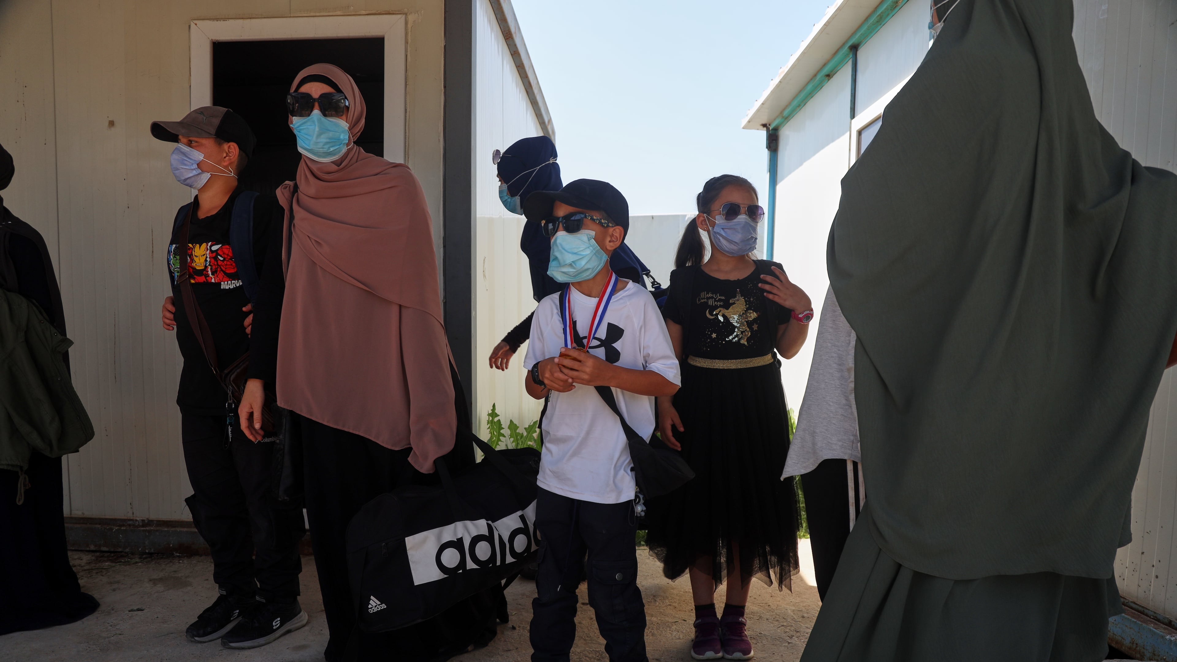 Members of Australian families at Roj Camp in eastern Syria, housing people with alleged ties to Islamic State militants, prepare to leave for Damascus as part of a second repatriation effort by Syrian authorities, at Roj Camp in eastern Syria, Friday, April 24, 2026. (AP Photo/Baderkhan Ahmad)