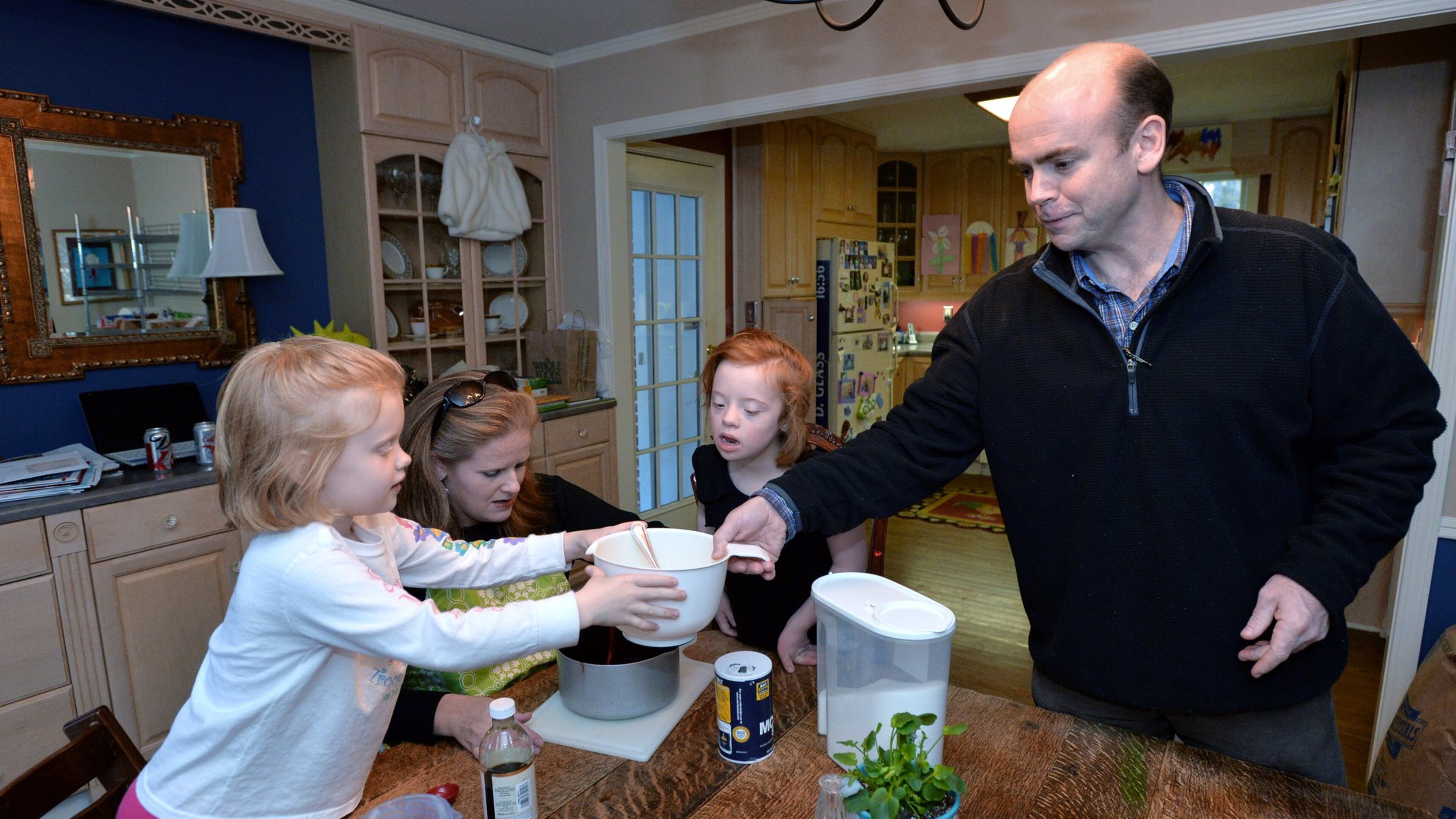 Darden Glass, third from left, 8, who who has Down Syndrome, and sister Anna, 6, help their parents Betsy and David Glass as they makes their popular fudge pie Darden’s Dangerously Delicious Fudge Pie at their home in Sandy Springs. What began as a contribution to a school bake sale for Glass and her husband David has turned into a full-fledge business called Darden’s Delights, named for Darden who has Down Syndrome. The Glasses donate a large portion of their revenue to organizations that support people with developmental disabilities.