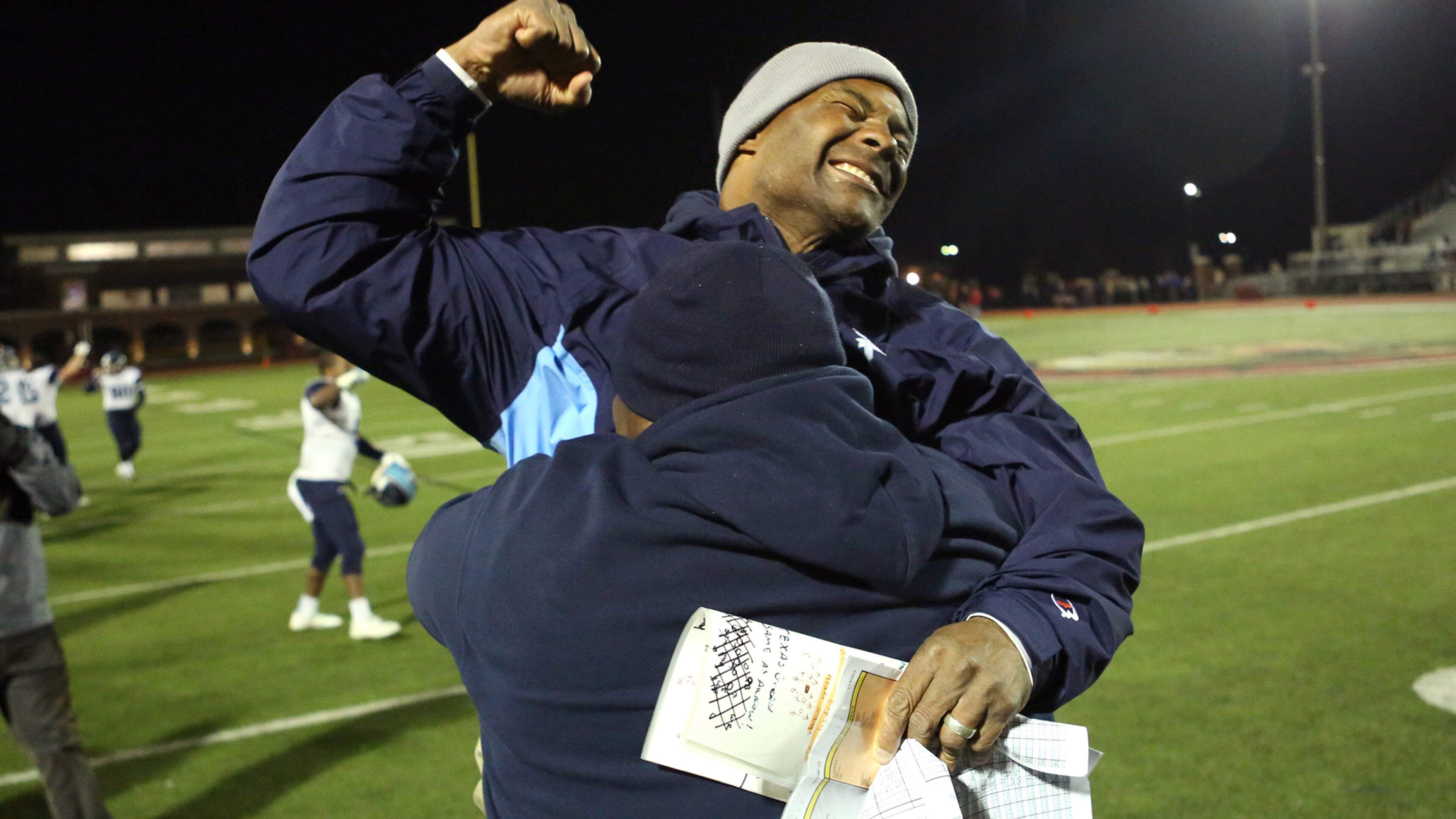 INTO THE FINALS--December 4, 2015 - Norcross, Ga: Pace Academy head coach Chris Slade, facing, celebrates with offensive coordinator Kevin Johnson after their win over GAC in the Class AA semi-final at Greater Atlanta Christian, Friday, December 4, 2015, in Norcross, Ga. Pace Academy defeated GAC 45-20. PHOTO / JASON GETZ