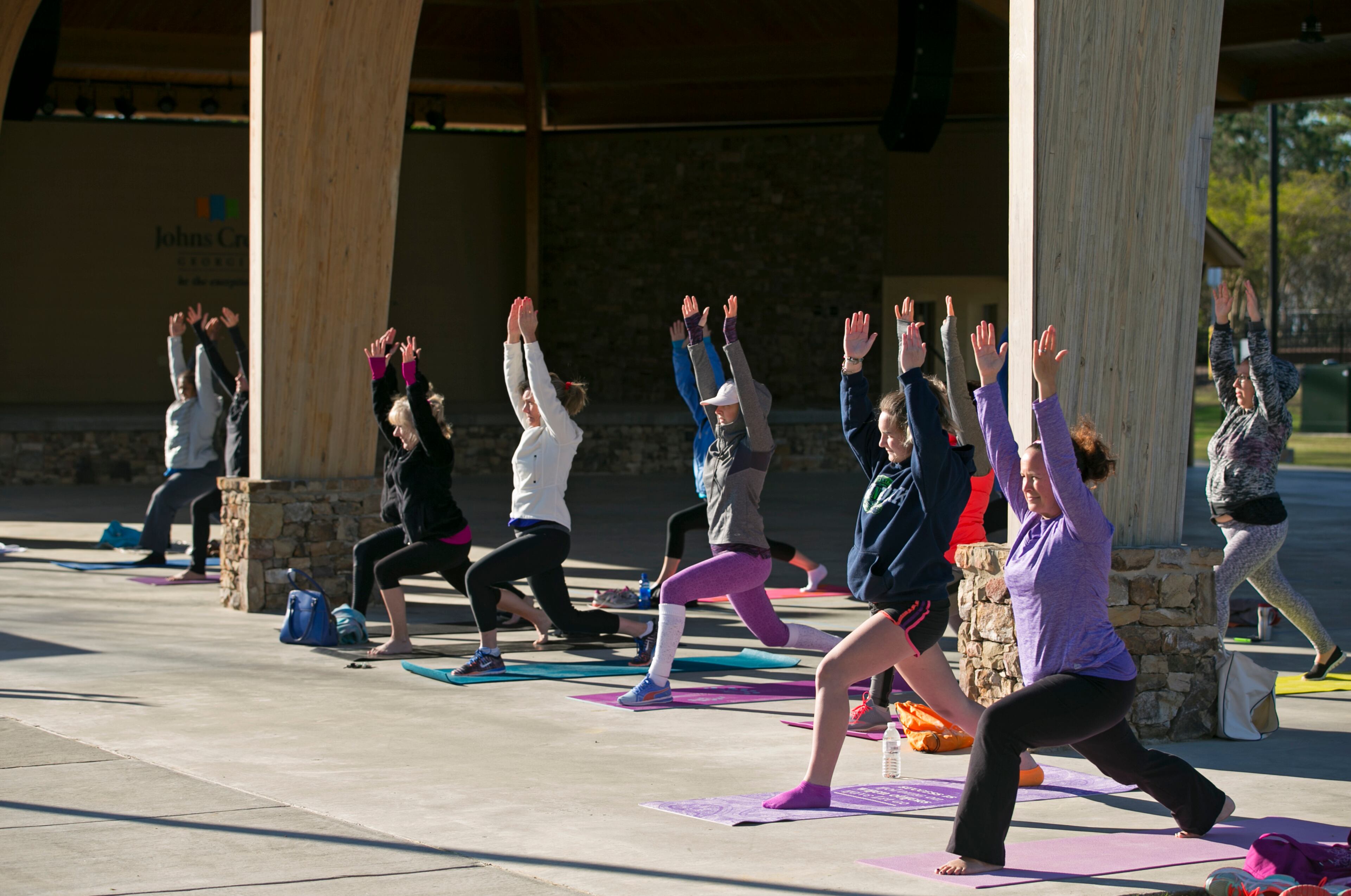 April 3, 2016 - Johns Creek, Ga: A group of women participate in a free yoga class at the Newtown Park Amphitheater at Newtown Park Sunday, April 3, 2016, in Johns Creek, Ga. The class was taught by Anissa Dearborn. This is for the insider's guide feature about the Newtown neighborhood. PHOTO / JASON GETZ