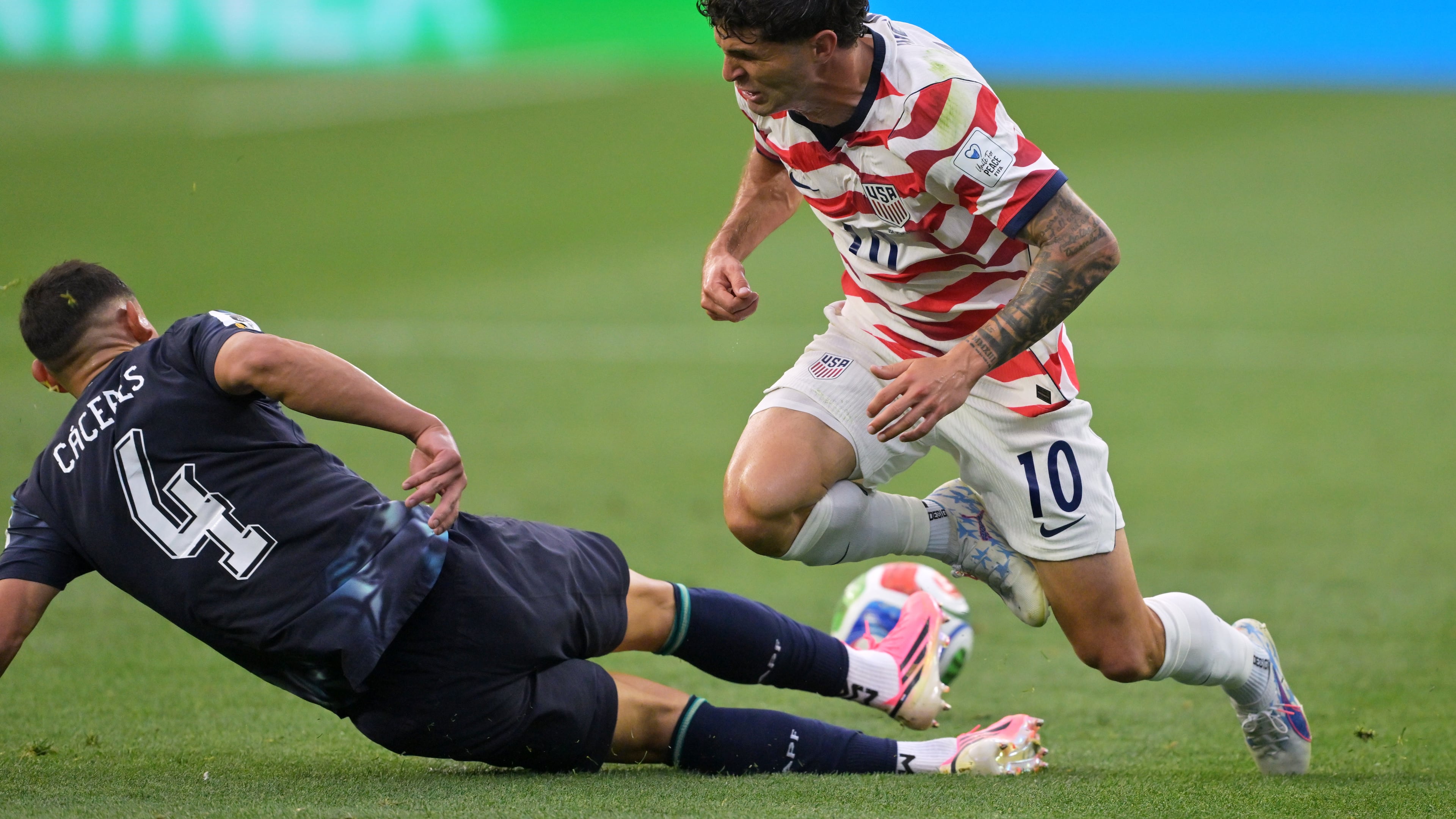 Paraguay's Juan Jose Caceres (4) tackles United States' Christian Pulisic (10) during the World Cup Group D soccer match in Inglewood, Calif., near Los Angeles, Friday, June 12, 2026. (AP Photo/Jayne Kamin-Oncea)