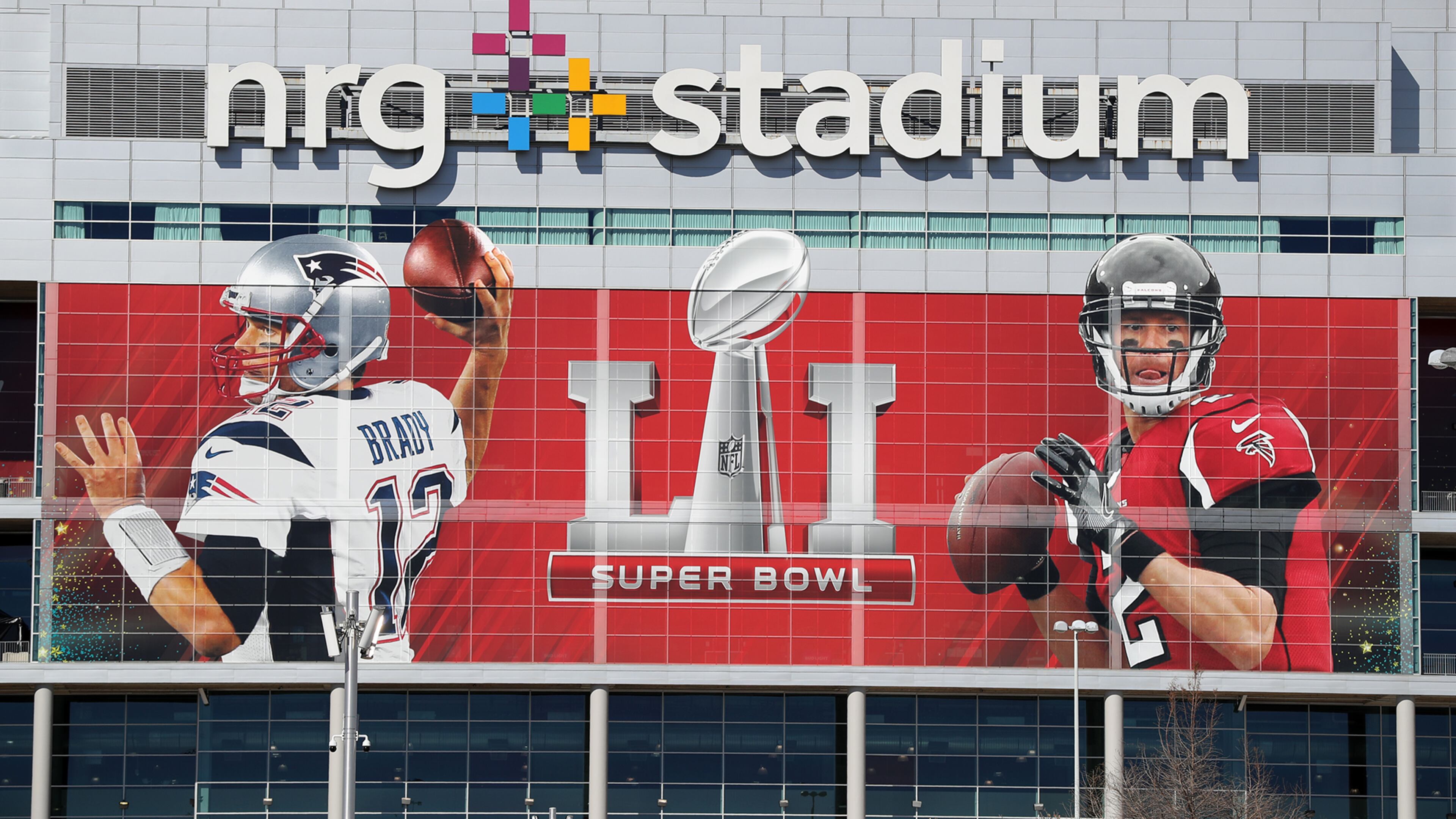 No doubt who the headliners are in this Super Bowl, as this giant likeness of the Falcons Matt Ryan and the Pats Tom Brady at the entrance to NRG Stadium will attest. (Curtis Compton/ccompton@ajc.com)
