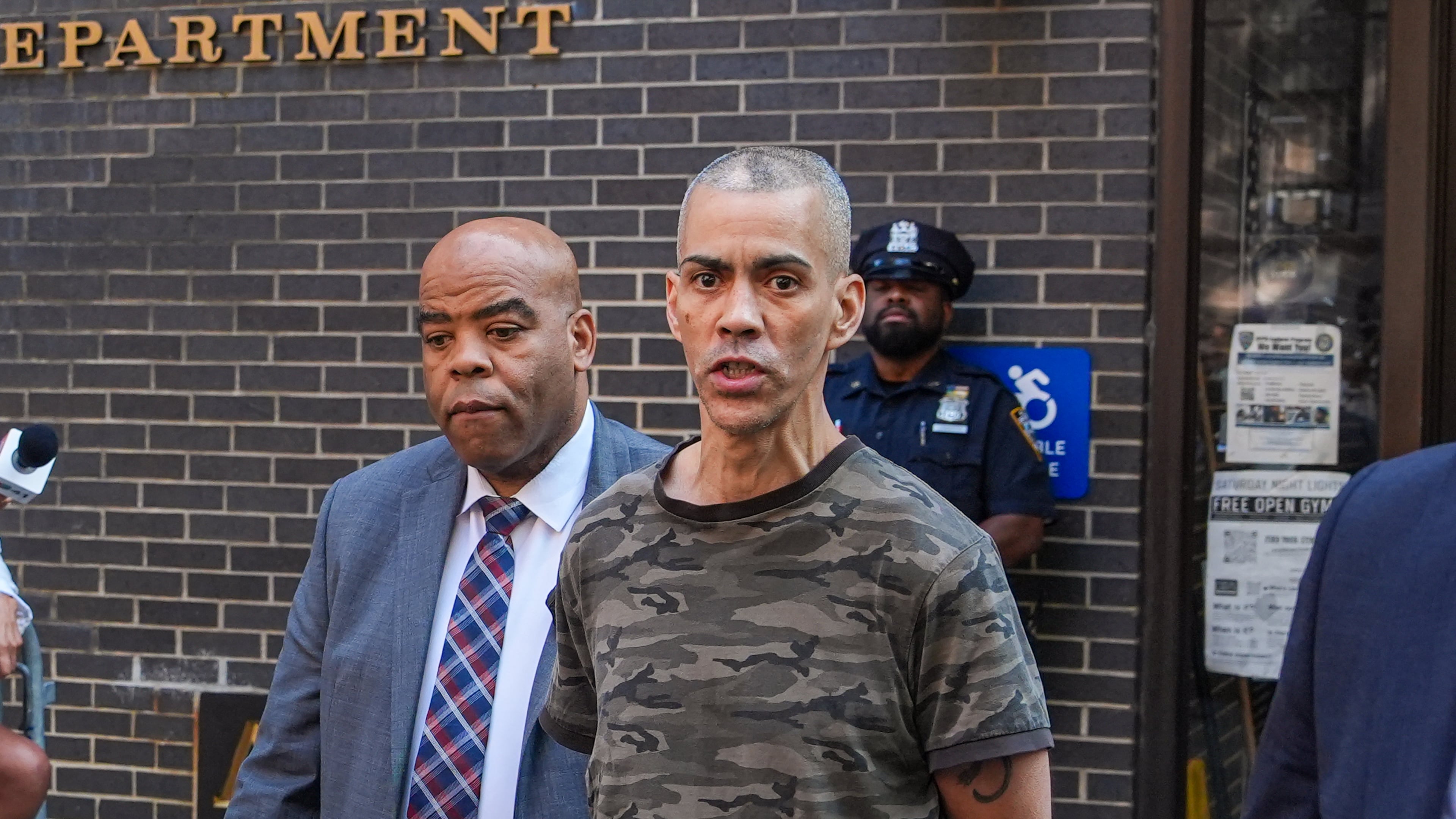 Raul Morales, a 51-year-old man who is accused of stabbing two people on the Upper West Side in Manhattan on Thursday afternoon is escorted out of the NYPD 20th Precinct by police officers in New York, Friday, July 24, 2026. (AP Photo/Ryan Murphy)
