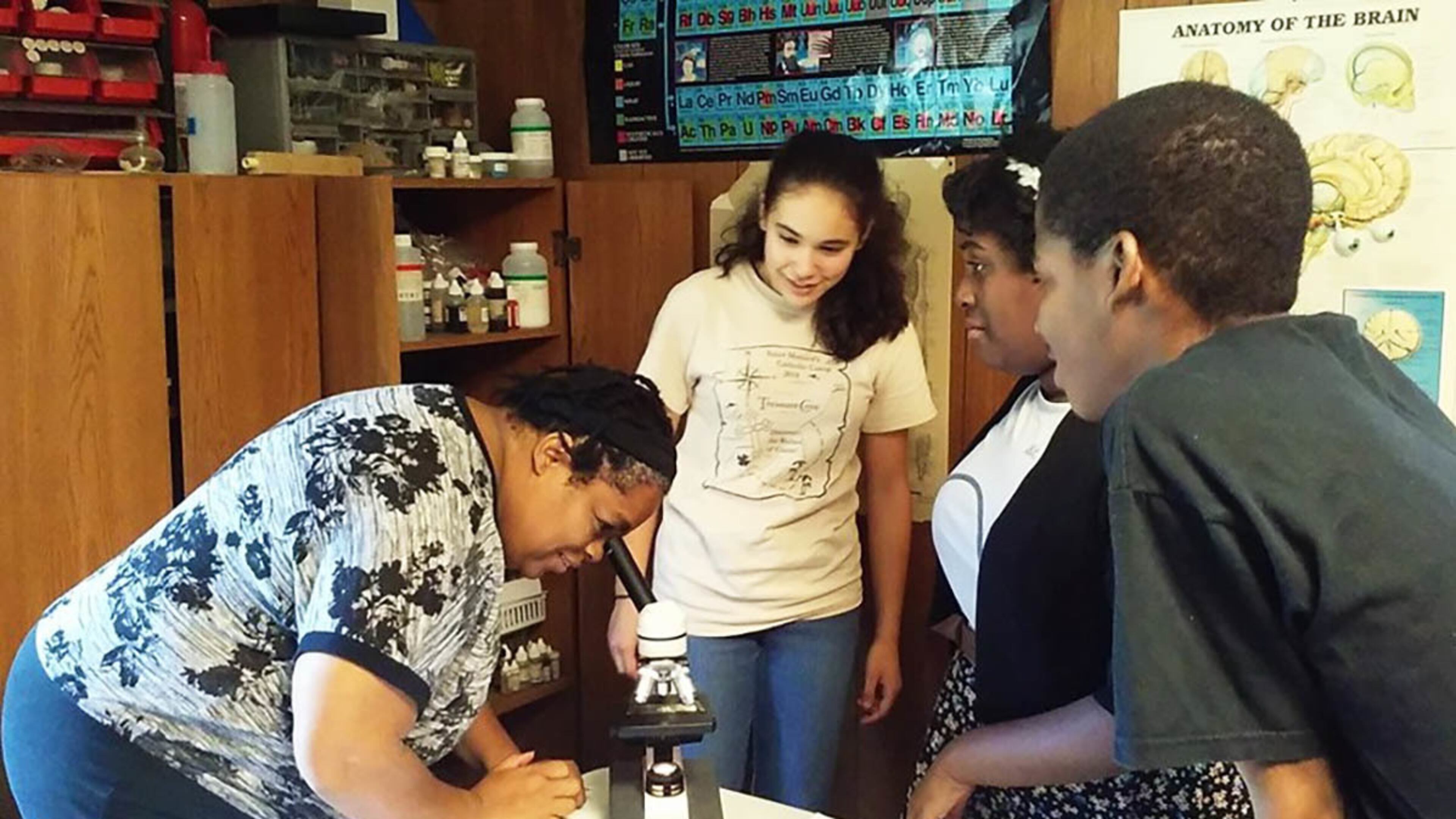 In addition to math, Angela Paul teaches science. Here, she's in the biology lab with students Joan Deitsch (from left), Adrianna Cauthen and Brandon Bosley.