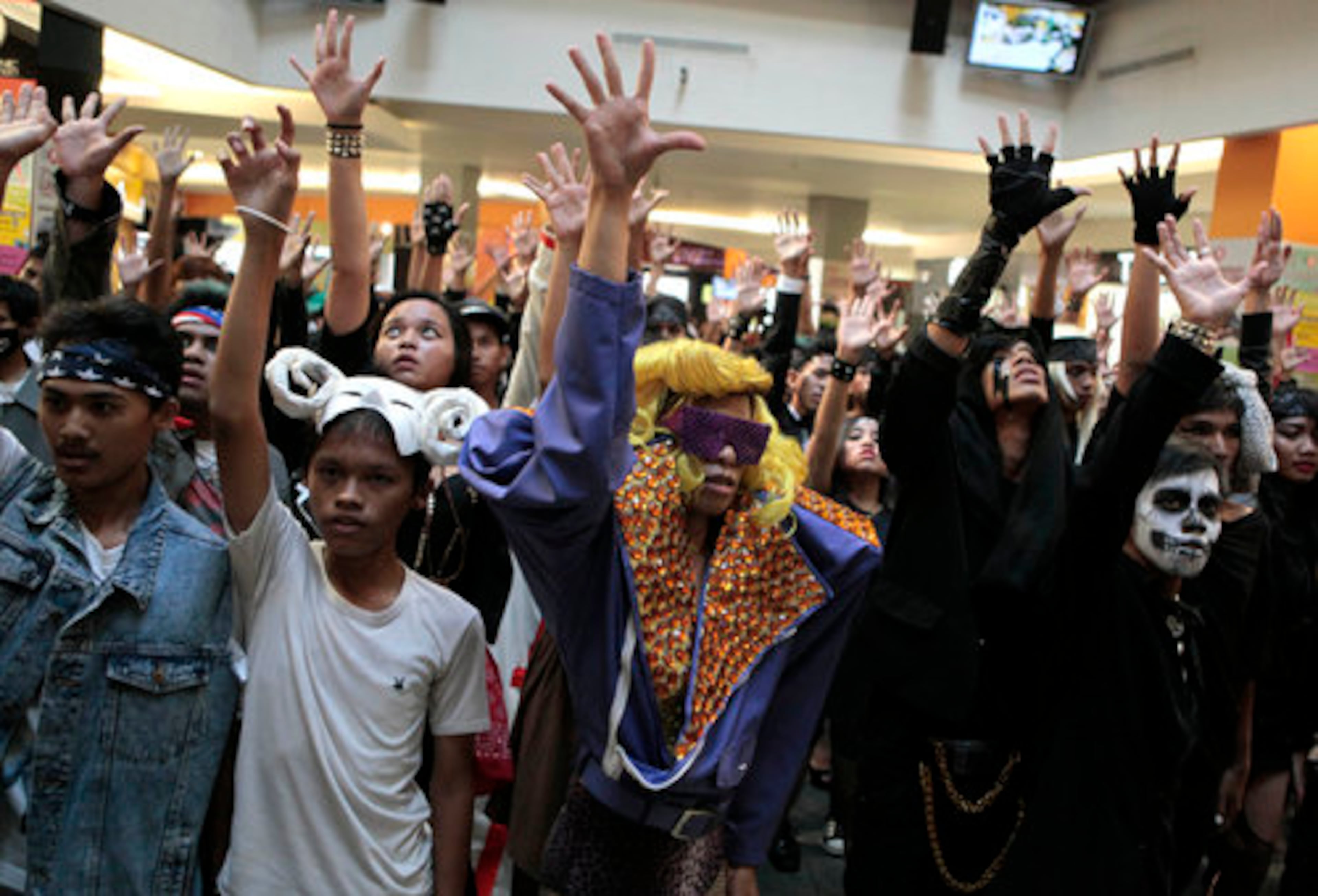 Fans of U.S. pop star Lady Gaga perform a flash mob at a shopping mall in Jakarta, Indonesia, on Sunday. Lady Gaga canceled her sold-out show in Indonesia after Islamist hard-liners threatened violence, claiming her sexy clothes and provocative dance moves would corrupt the youth. The flash mob followed protests in the city.