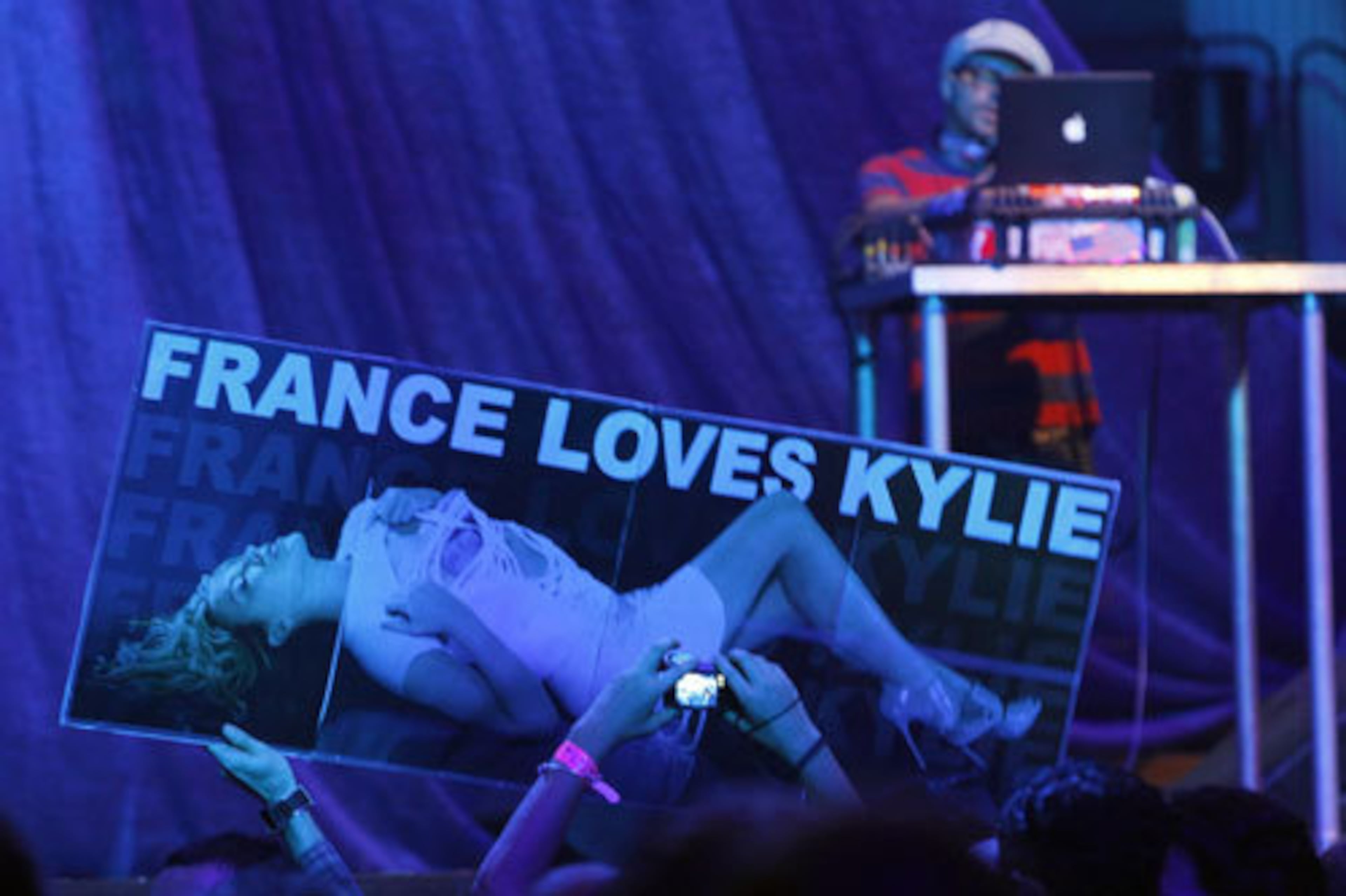 Fans hold up a placard as they wait for the show to begin.