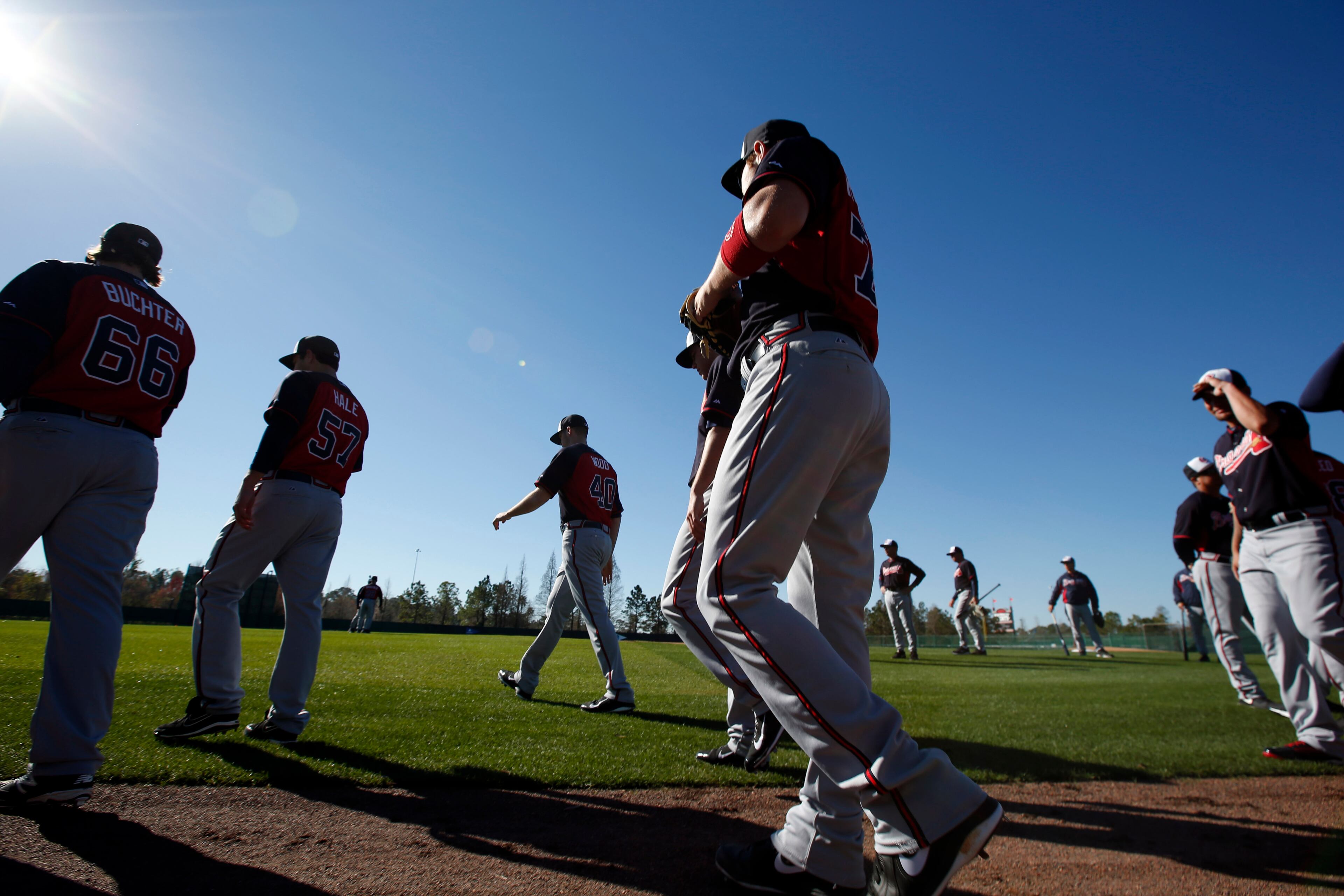 The Atlanta Braves walk on the field at the start of a spring training baseball workout on Sunday, Feb. 16, 2014, in Kissimmee, Fla. (AP Photo/Alex Brandon)