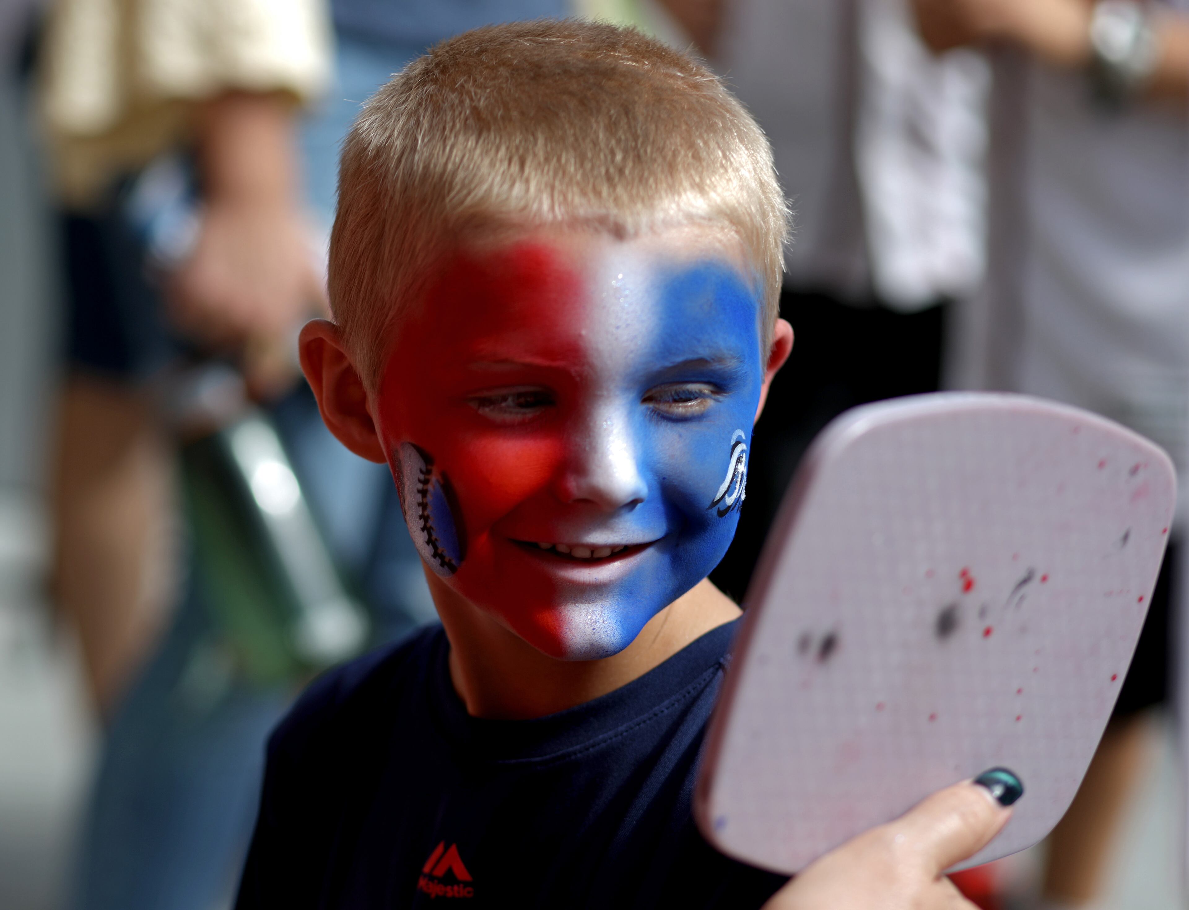 Henry Adams, 5, of Braselton, Ga., reacts after he had his face painted. (JASON GETZ/SPECIAL TO THE AJC)