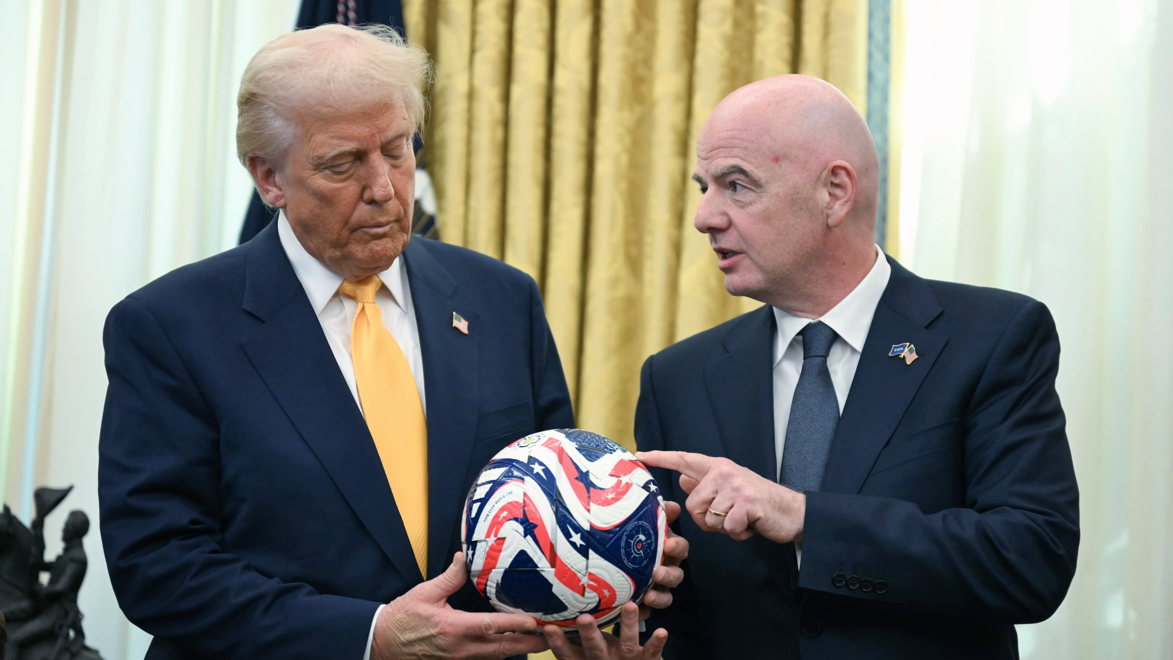 FILE - FIFA President Gianni Infantino, right, presents President Donald Trump with the new FIFA Club World Cup official ball in the Oval Office of the White House in Washington, March 7, 2025. (Jim Watson/Pool Photo via AP, file)