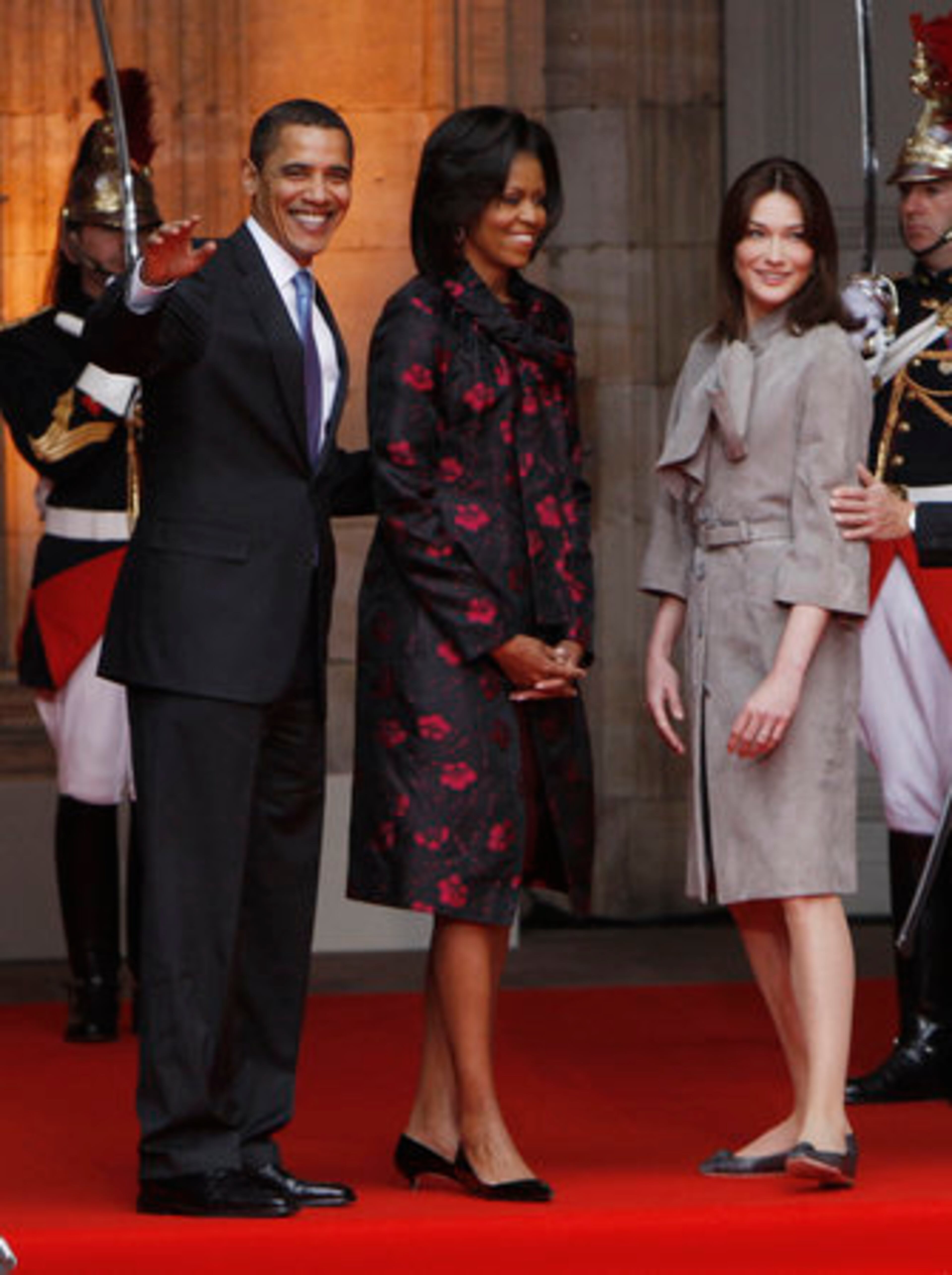 Michelle's designer, Thakoon Panichgul, a Thai-born designer who grew up in the States. His label Thakoon launched in 2004. Carla's designer: Dior, of course. Actually, it's a velvet lambskin coat from his fall 2009 collection that costs about $6,000.