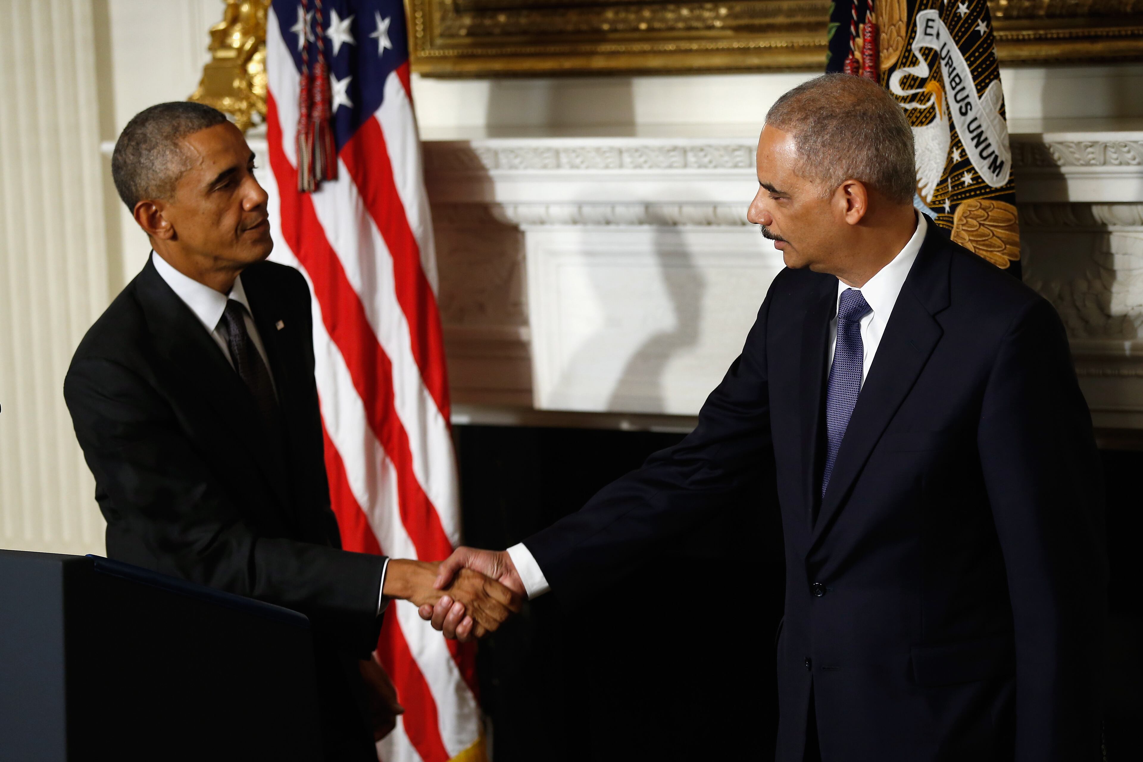 WASHINGTON, DC - SEPTEMBER 25: US President Barack Obama shakes hands with Attorney General Eric H. Holder Jr. who announced his resignation today, September 25, 2014 in Washington, DC. President Obama said that Mr. Holder will remain in office until a successor is nominated and confirmed. (Photo by Win McNamee/Getty Images)