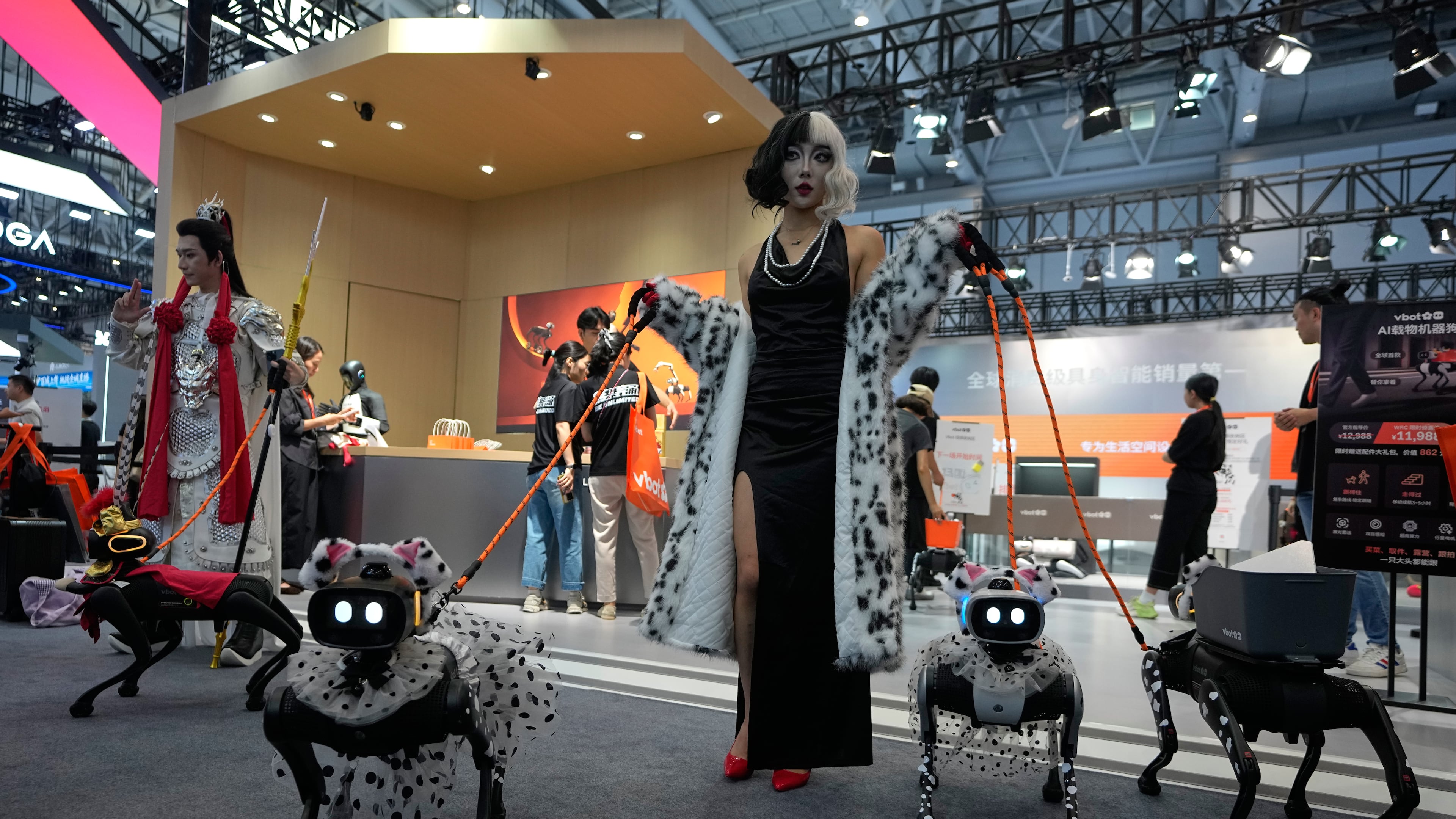 Models showing their robotic dogs with fancy dressing at a booth during the World Robot Conference at the Beiren Yichuang International Convention and Exhibition Centre in Beijing, Wednesday, Aug. 19, 2026. (AP Photo/Andy Wong)