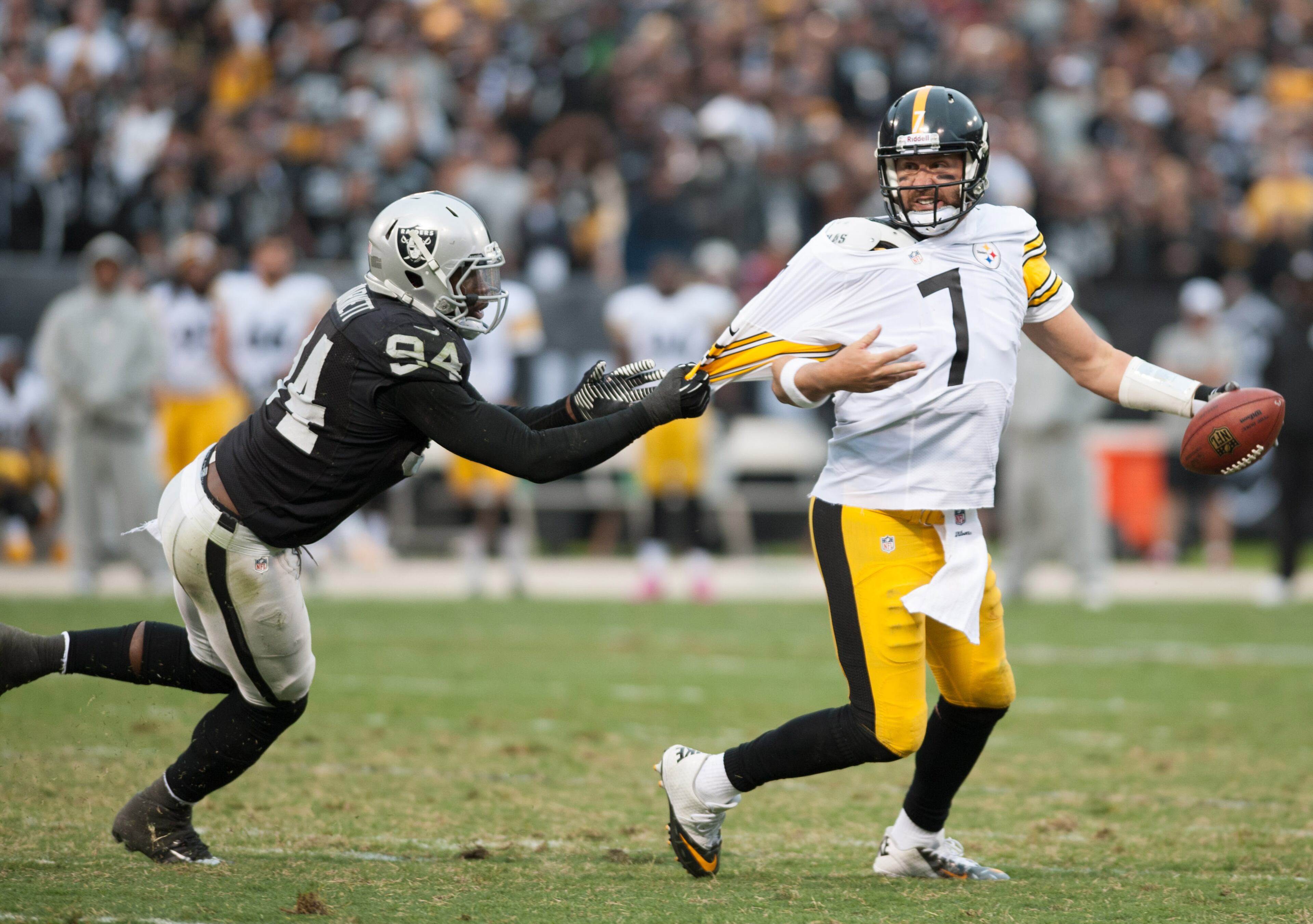 Pittsburgh Steelers quarterback Ben Roethlisberger (7) attempts to escape from the grasp of Oakland Raiders outside linebacker Kevin Burnett (94) during the fourth quarter at O.co Coliseum. The Oakland Raiders defeated the Pittsburgh Steelers 21-18. Mandatory Credit: Ed Szczepanski-USA TODAY Sports
