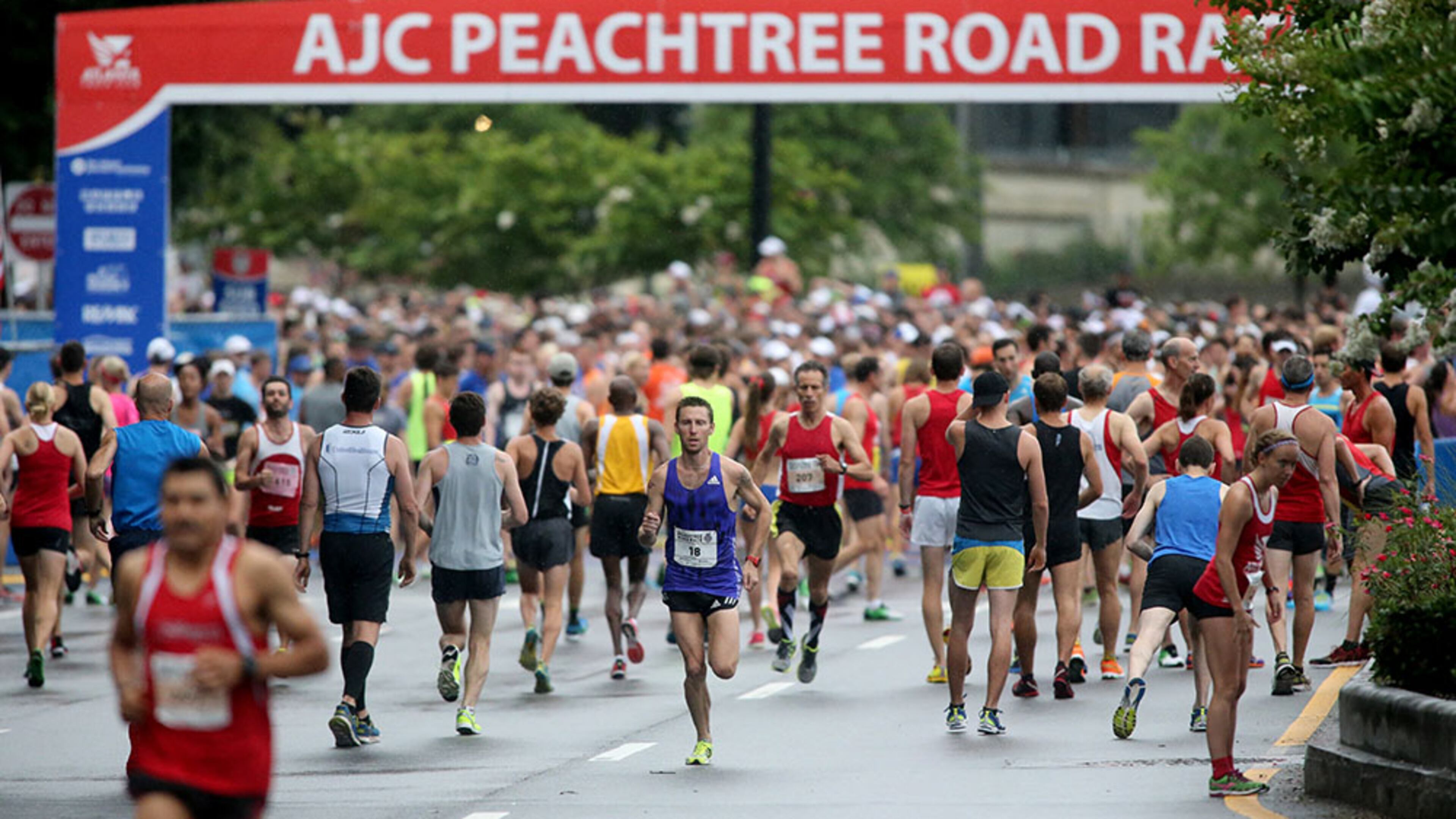 July 4, 2015 - Atlanta, Ga: Runners warm-up before the start of the 46th running of the Atlanta Journal-Constitution Peachtree Road Race Saturday morning in Atlanta, Ga., July 4, 2015. JASON GETZ / PHOTO