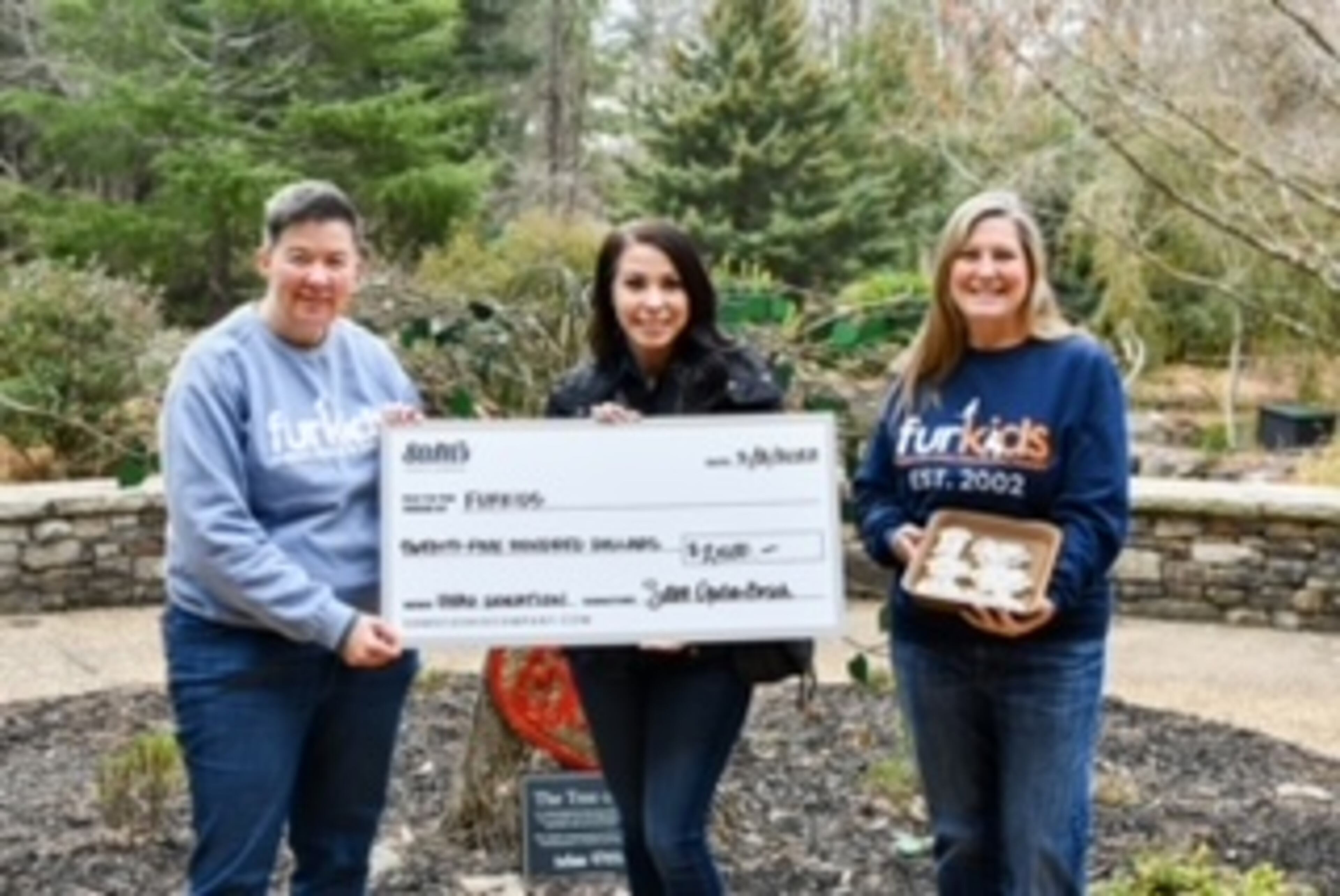 Sam Opdenbosch, owner of Sam’s Cookie Company and winner of the Christmas Cookie Challenge donates a portion of her winnings to Furkids. (L-R: Christina Bray, director of development; Sam Opdenbosch; and Samantha Shelton, CEO and founder).