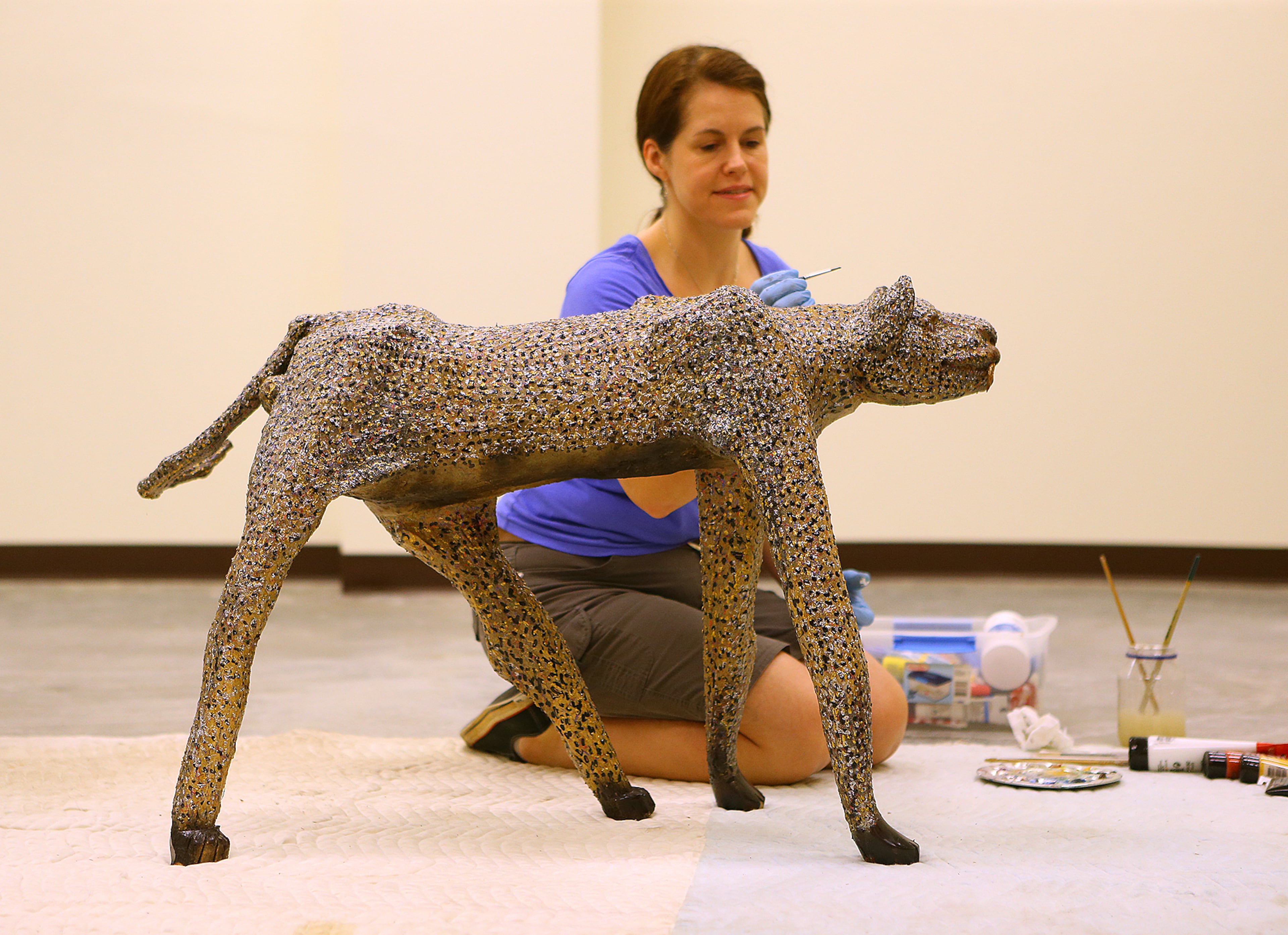 Objects conservator Nancy Livengood repairs some minor damage to the display piece “Moses the Leopard” by O.L. Samuels in preparation for the opening of the Tubman Museum of African American Art, History and Culture on Wednesday, May 6, 2015, in Macon. Curtis Compton / ccompton@ajc.com