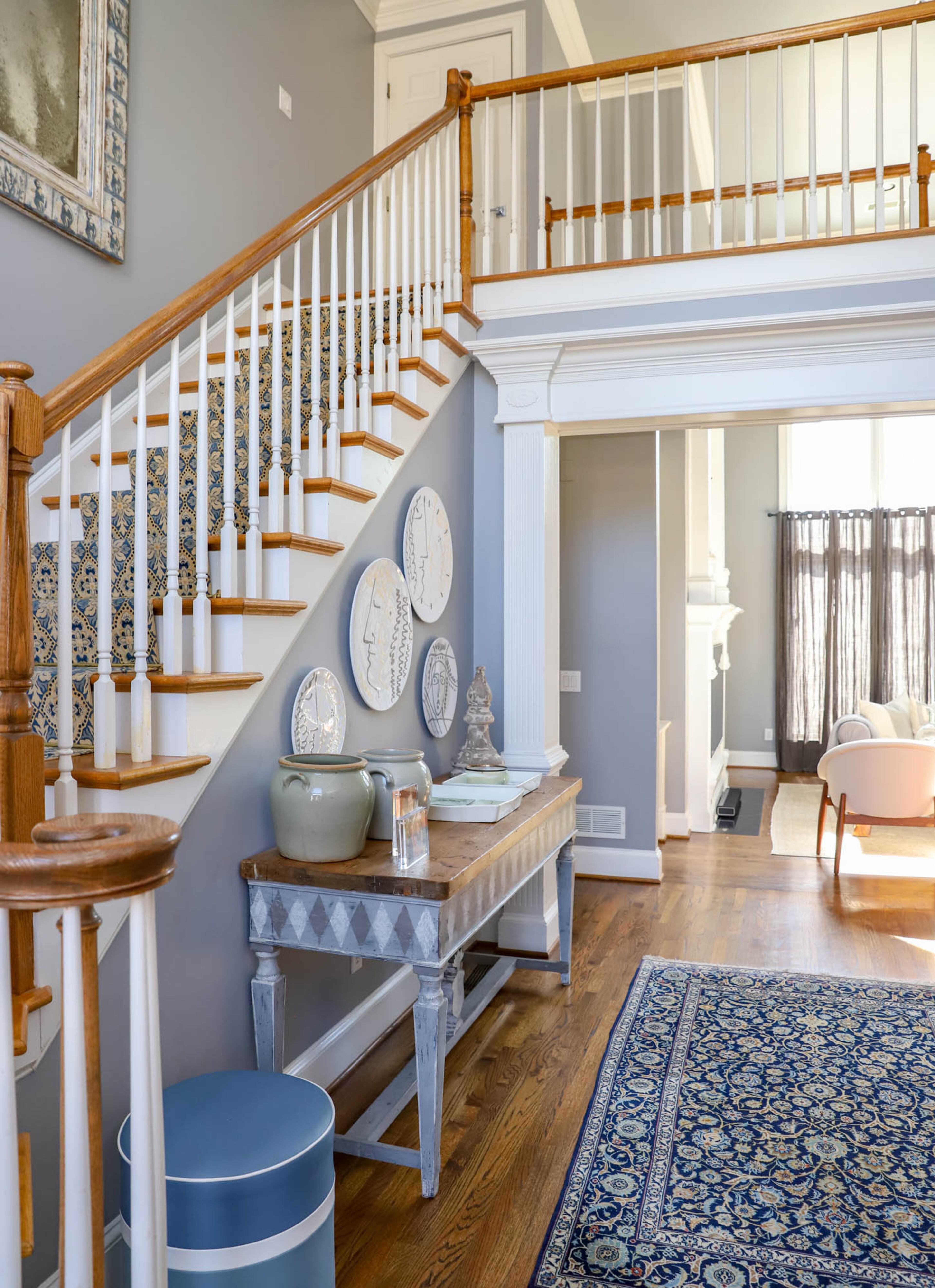 The foyer of Joe and Stacy Borocz’s Roswell home is light and inviting. Against one wall sits an antique oak top table with a harlequin print that used to serve as a ticket counter from a French theater that Stacy placed there to give the space a more playful feel. Text by Shannon Dominy/Photo by Reynolds Rogers