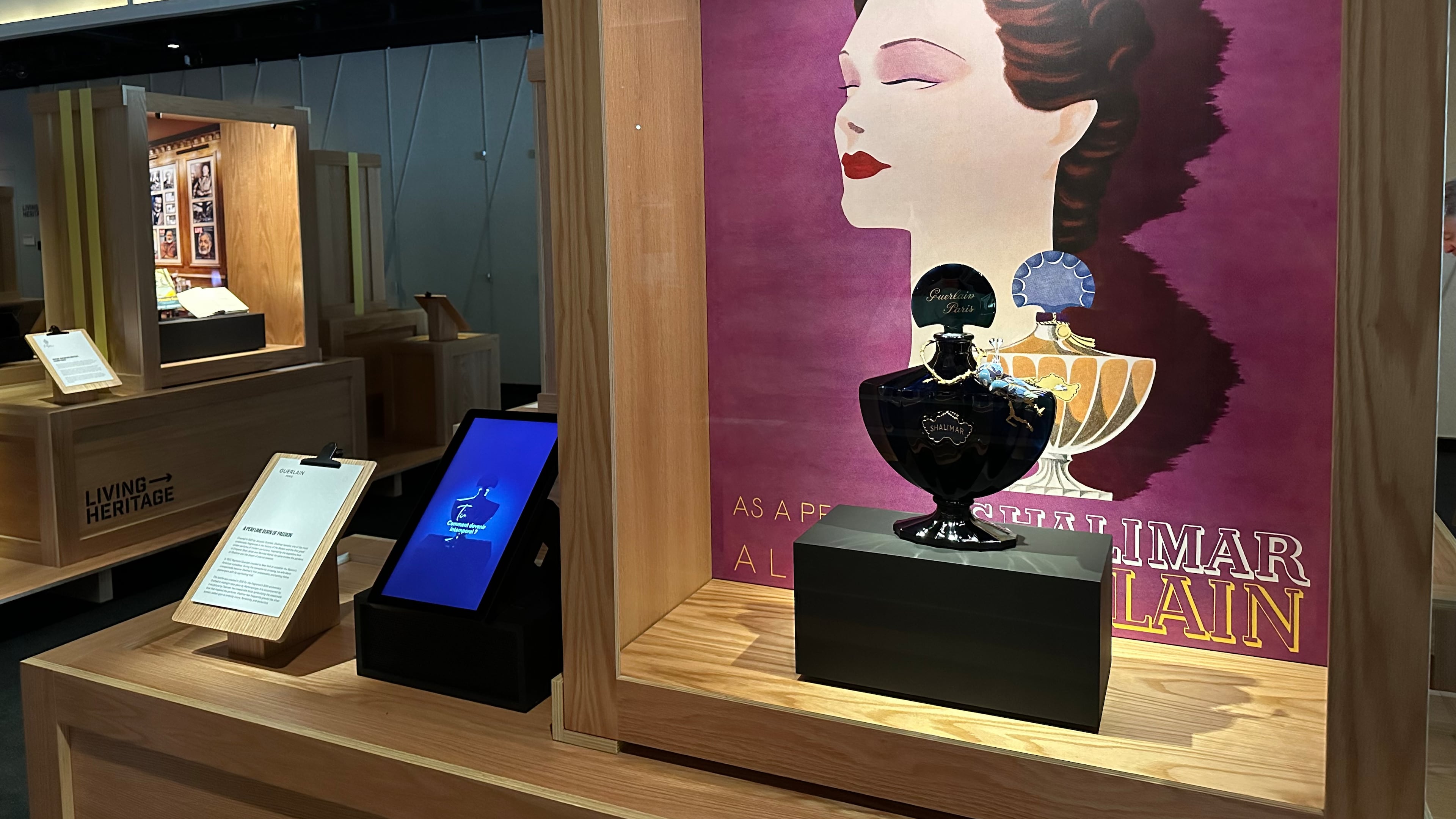 An advertisement from 1935 and a midnight-blue perfume bottle for Jacques Guerlain's Shalimar fragrance pictured on are display as part of the Comite Colbert "Hidden Treasures" exhibit at The Shed on Tuesday, May 26, 2026, in New York. (AP Photo/Beatrice Dupuy)