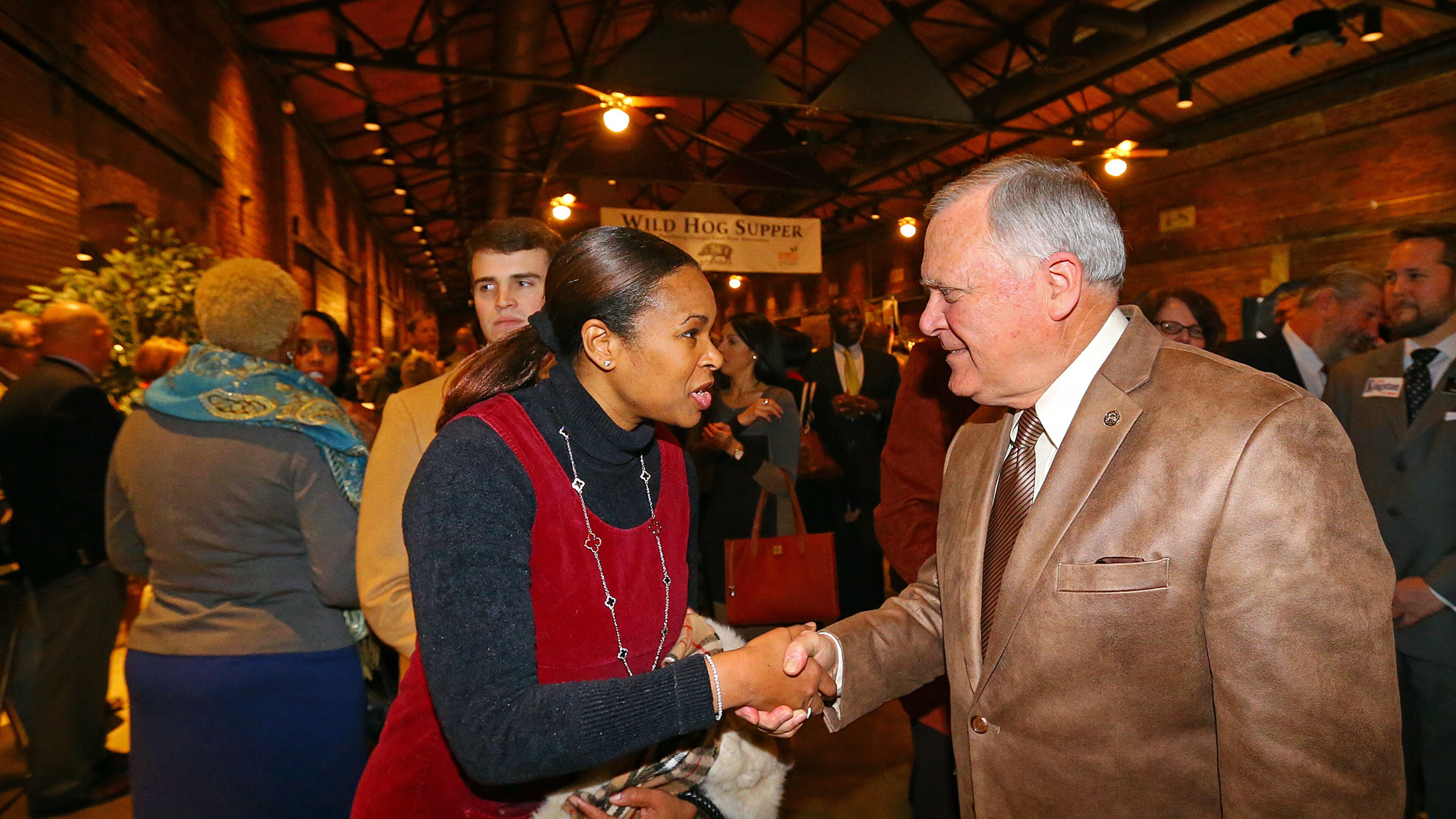 Linda Pritchett is in next week’s runoff election to replace former Sen. Vincent Fort. She's seen here shaking Gov. Nathan Deal's hand at the Wild Hog Supper on Jan. 12, 2014.