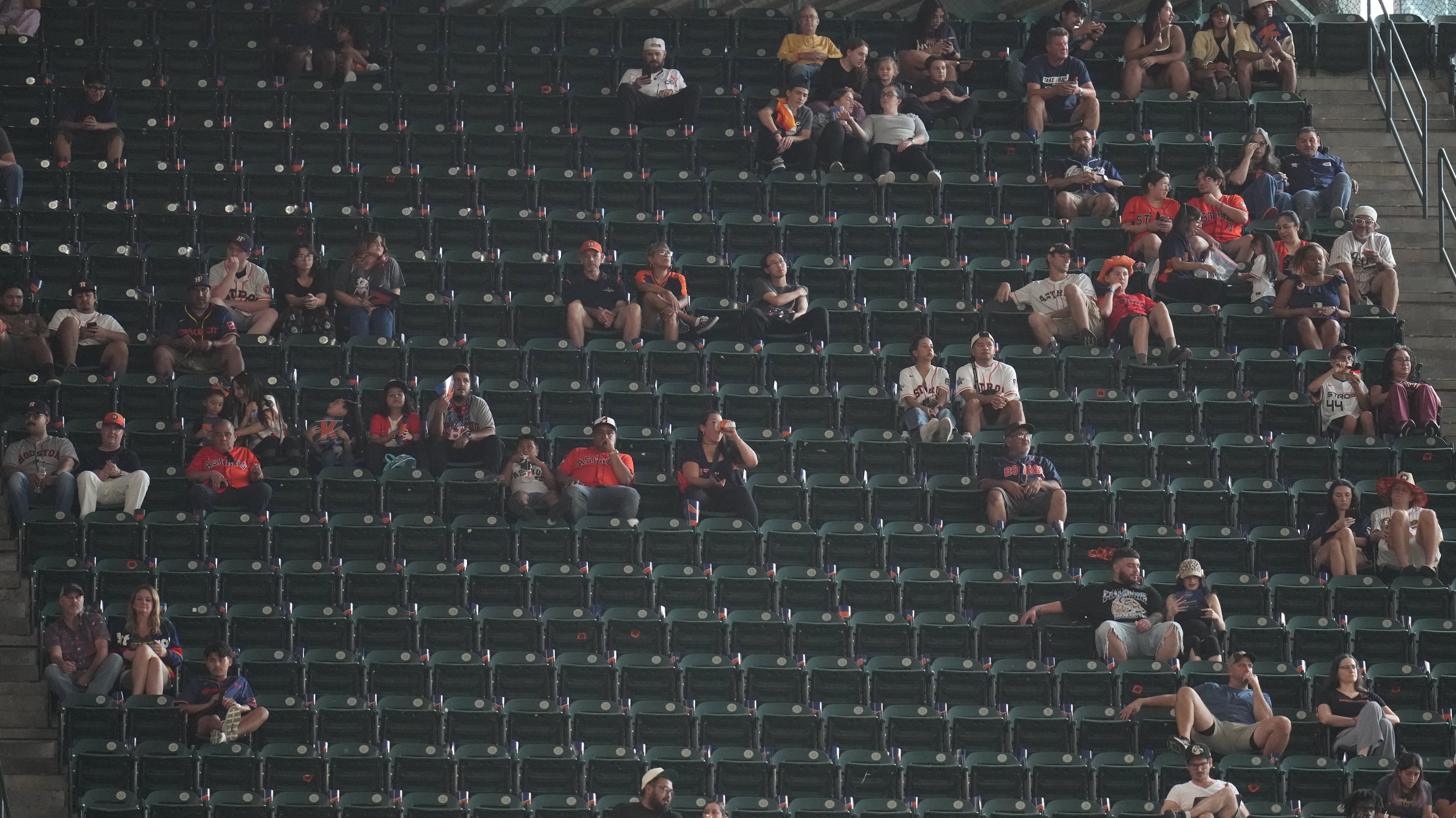 Fans sit among empty seats during the second inning in Game 1 of baseball's American League Wild Card Series between the Houston Astros and Chicago White Sox, Tuesday, Sept. 29, 2026, in Houston. (AP Photo/Karen Warren