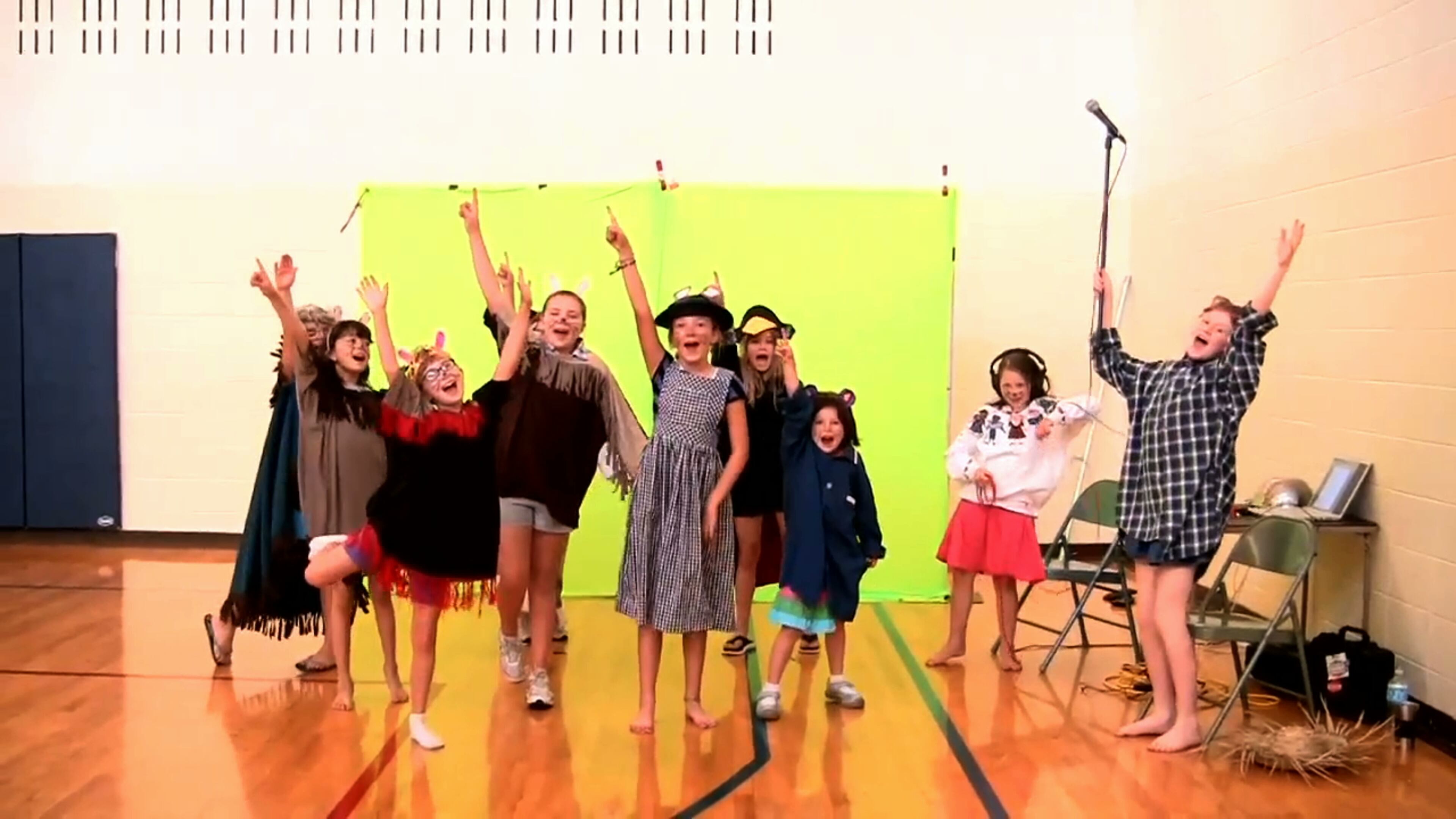 A kid-made video is taped in front of a greenscreen for "Mrs. Frisby and the Rats of NIMH," an entry in the "90-Second Newberry Film Festival." The fest results from an annual contest in which kid filmmakers create videos that tell the entire stories of Newbery-winning books in 90 seconds or less at the Decatur Library Stage.