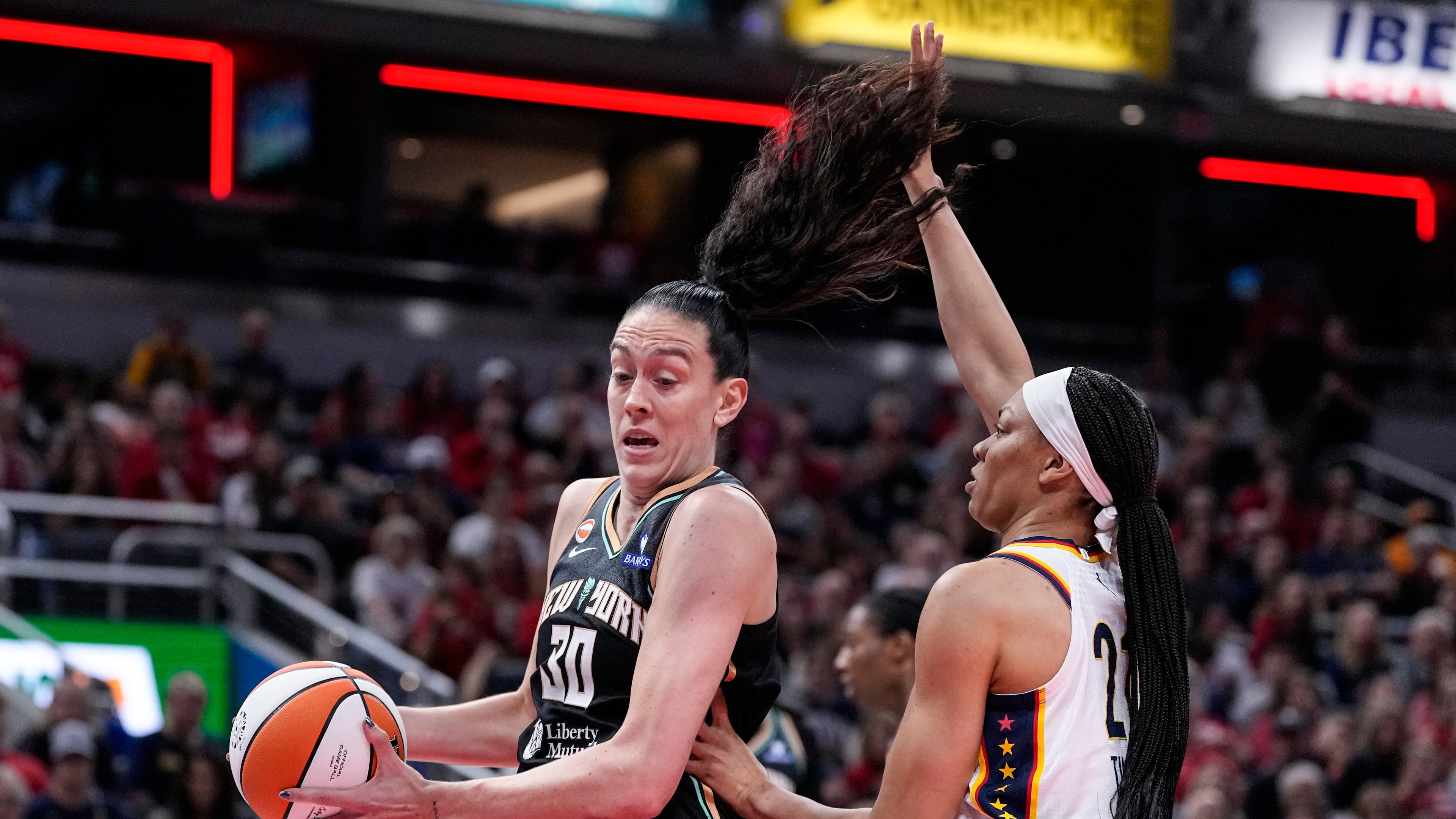 Indiana Fever forward Makayla Timpson (21) defends New York Liberty forward Breanna Stewart (30) in the first half of a WNBA basketball game in Indianapolis, Tuesday, Aug. 11, 2026. (AP Photo/Michael Conroy)