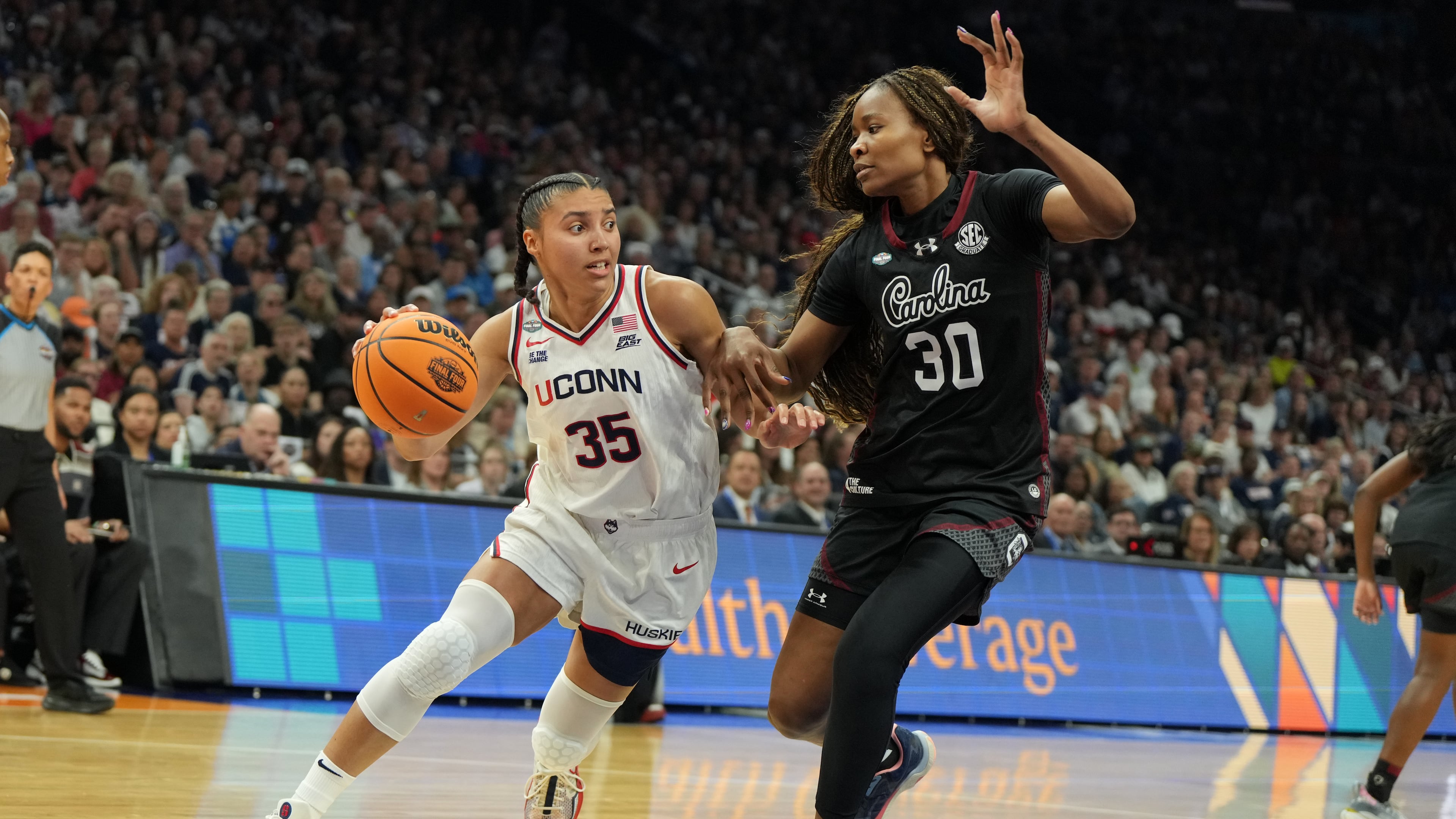 UConn guard Azzi Fudd (35) drives against South Carolina forward Maryam Dauda (30) during the first half of a woman's NCAA college basketball tournament semifinal game at the Final Four, Friday, April 3, 2026, in Phoenix. (AP Photo/Rick Scuteri)
