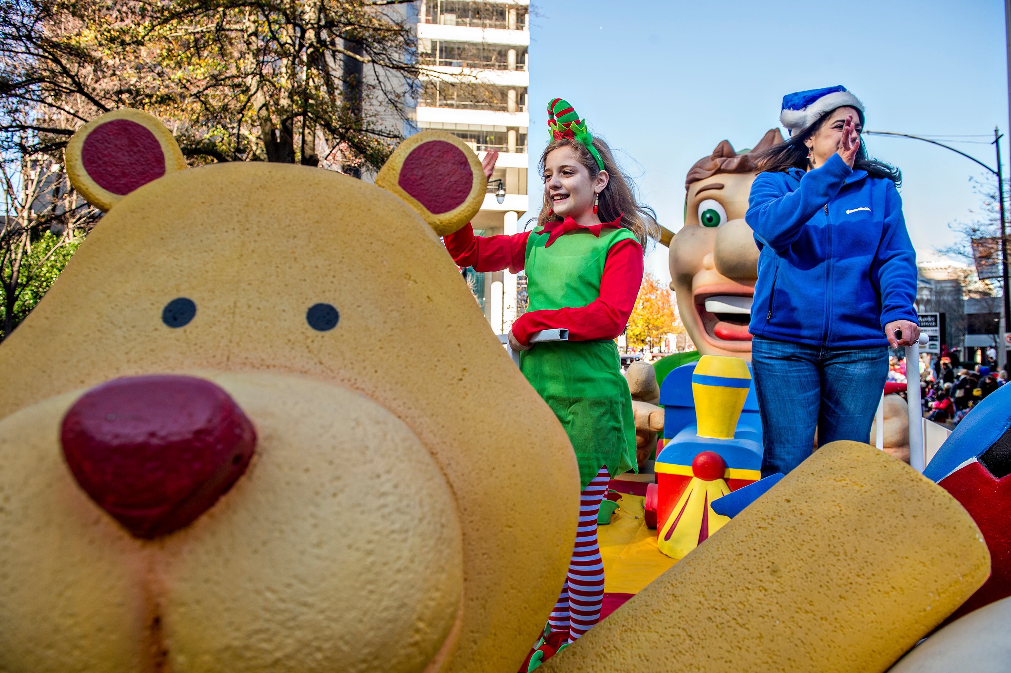 December 5, 2015 Atlanta - Caroline Evans (left) and her mother Katherine wave to the crowd during the 2015 Children's Christmas Parade in Atlanta on Saturday, December 5, 2015. Thousands gathered along Peachtree St. to watch the parade pass with marching bands, balloons, performances and more. JONATHAN PHILLIPS / SPECIAL