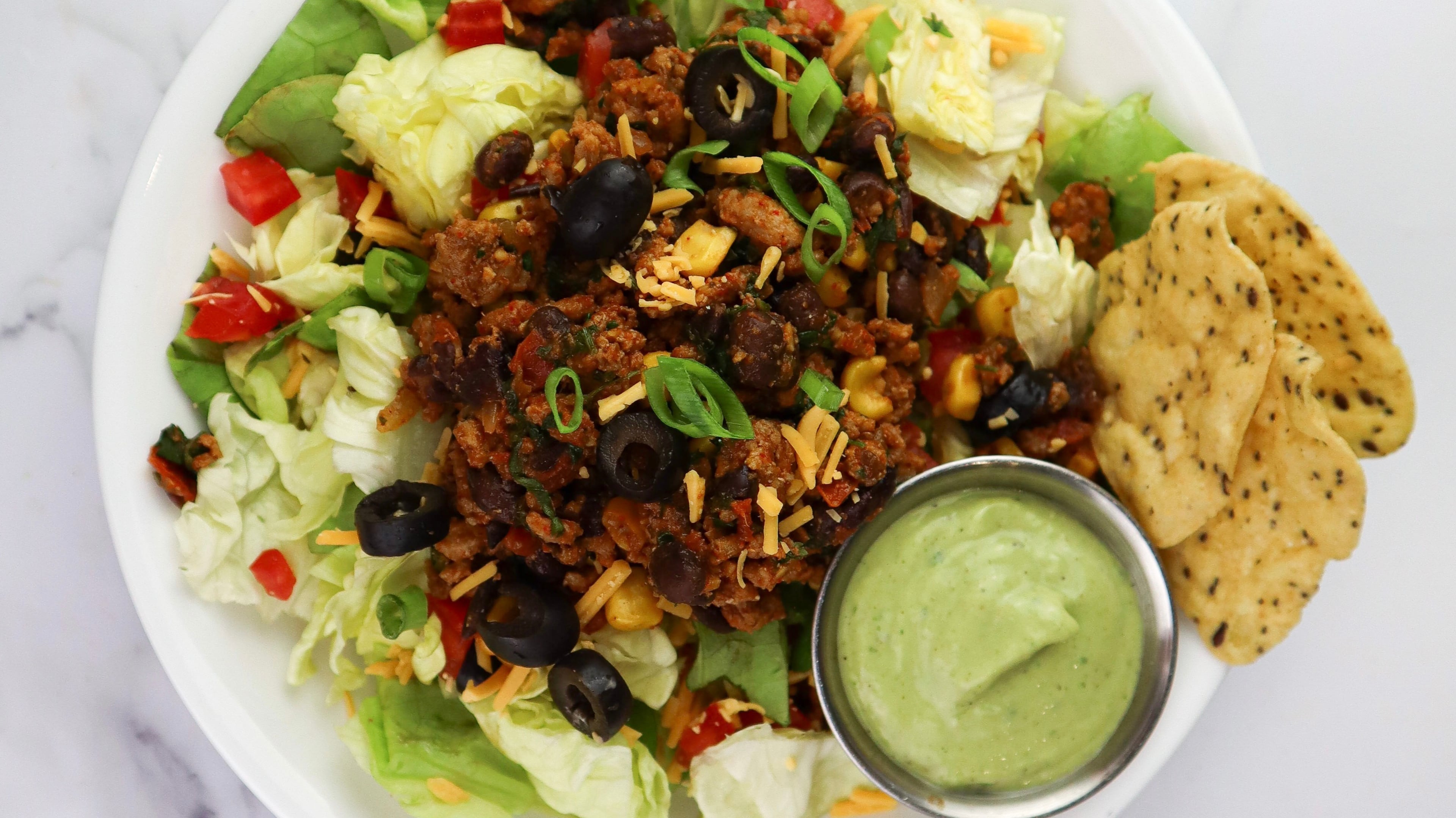 Perfectly Portioned Nutrition’s Turkey Taco Salad with Avocado Crema. (Courtesy of Kay Social)