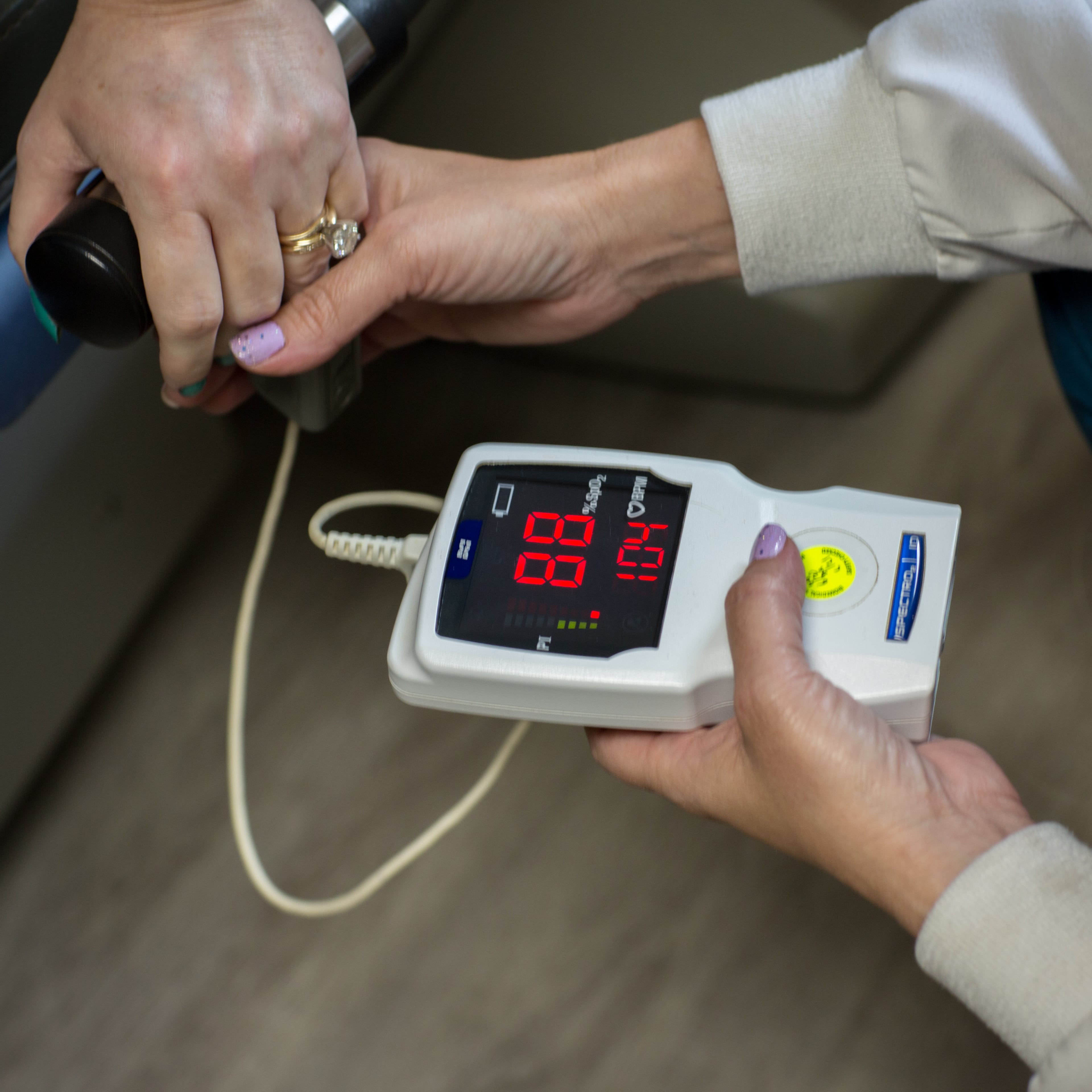 During a short exercise on a recumbent bicycle, pulmonary therapist Christie Simmons checks Lisa Martin’s blood oxygen level and heart rate. Simmons stopped the test after Martin’s blood oxygen levels dropped below 88%. (AJC Photo/Stephen B. Morton)