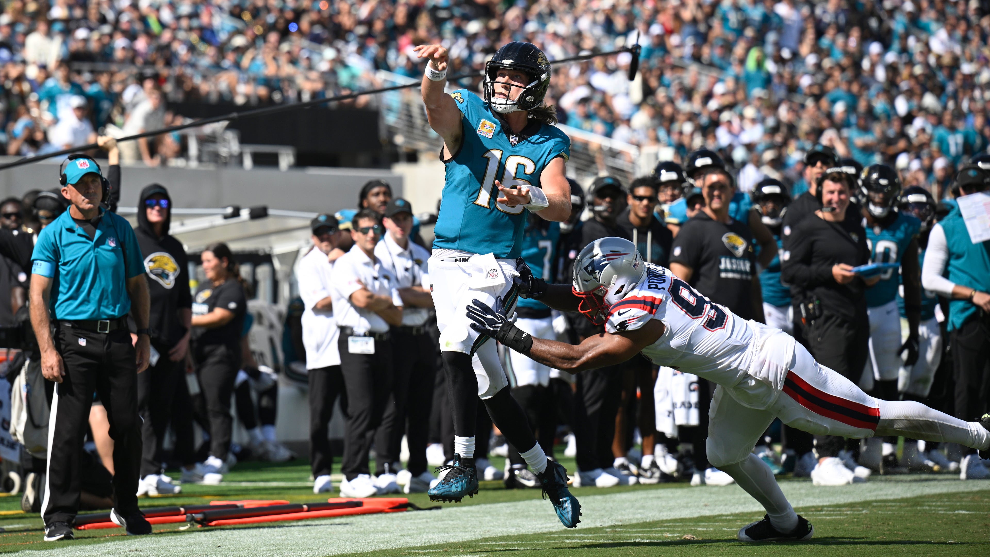 Jacksonville Jaguars quarterback Trevor Lawrence (16) passes against New England Patriots linebacker Elijah Ponder (91) in the second half during an NFL football game in Jacksonville, Fla., Sunday, Sept. 27, 2026. (AP Photo/Phelan M. Ebenhack)